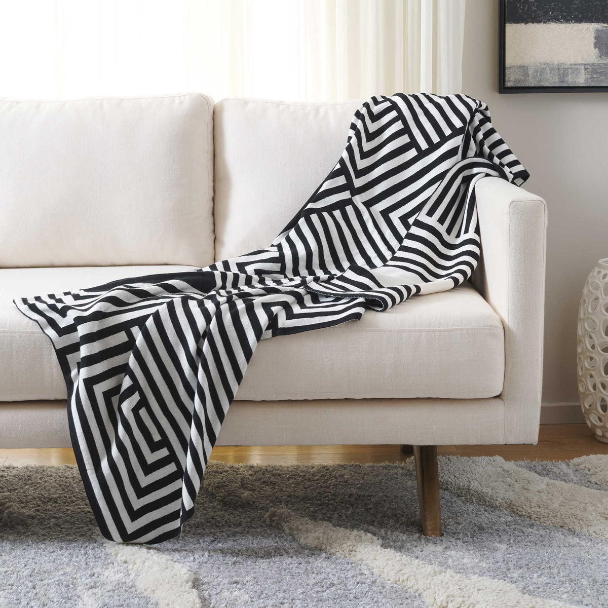 Modern black and ivory throw brings bold graphic contrast and inviting texture to your sofa