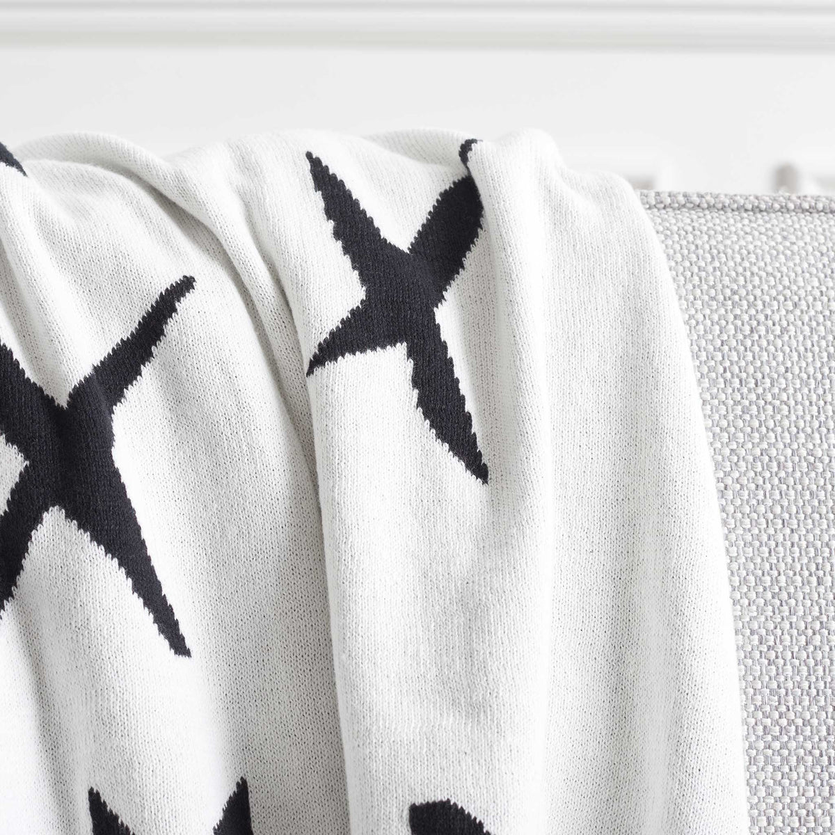 Smooth cotton knit with graphic black Xs on bright ivory for a fresh, minimalist look