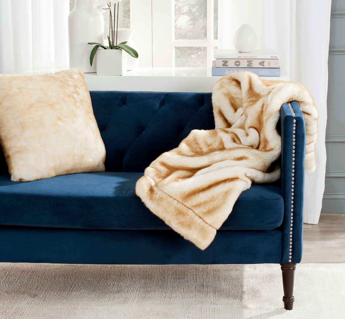 A golden tan throw adds inviting texture to a navy sofa. || THR702A-5060 || front_room