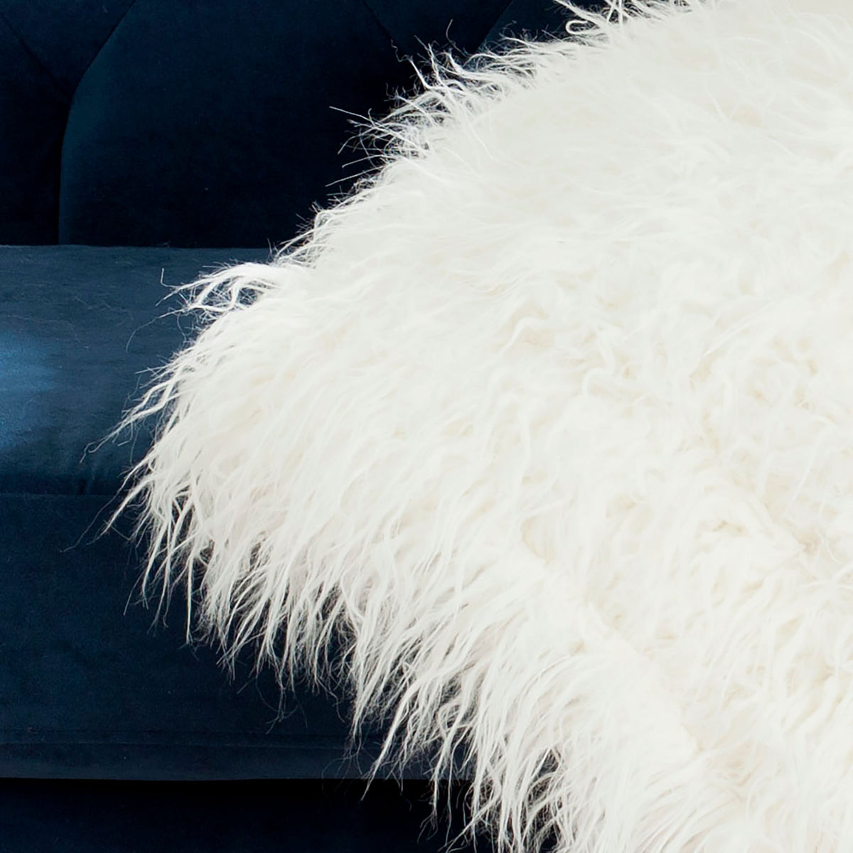 Long, wispy faux fur fibers give this snow-white throw a plush, inviting texture. || THR704A-5060 || detail_room