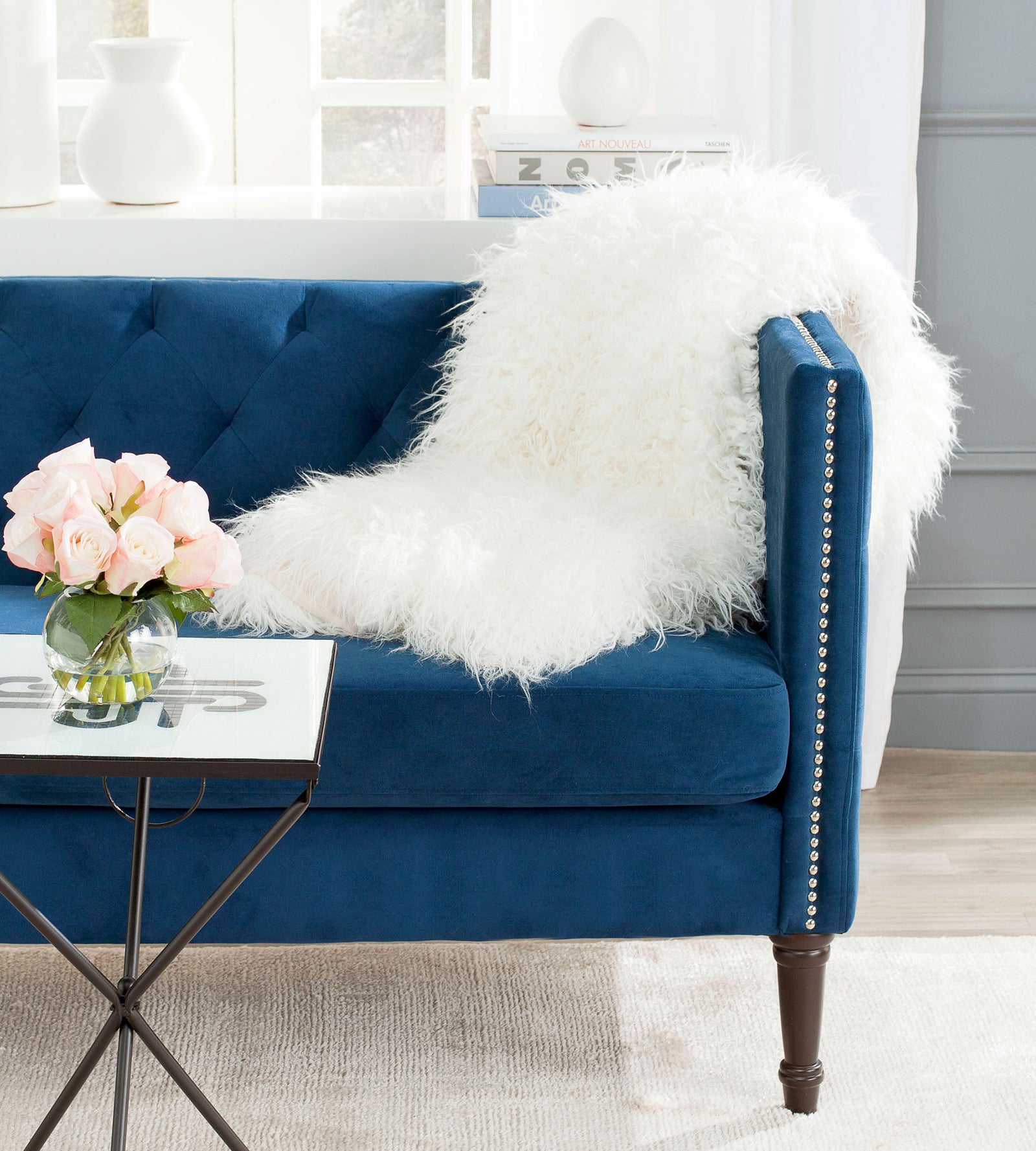Snow-white faux fur gathers across a sofa seat and arm for a cozy layer of texture. || THR704A-5060 || front_angle_room