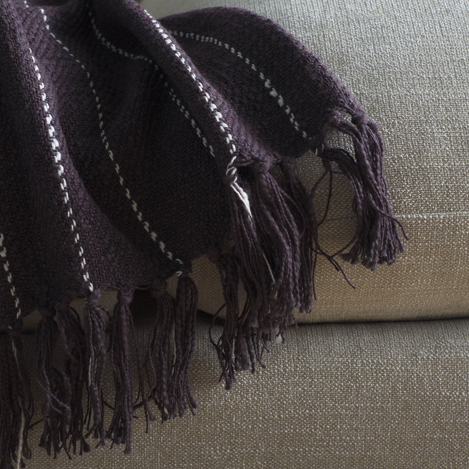 Long fringe finishes the charcoal gray cotton throw, accented with fine white stripes. || THR858A-5070 || corner_room