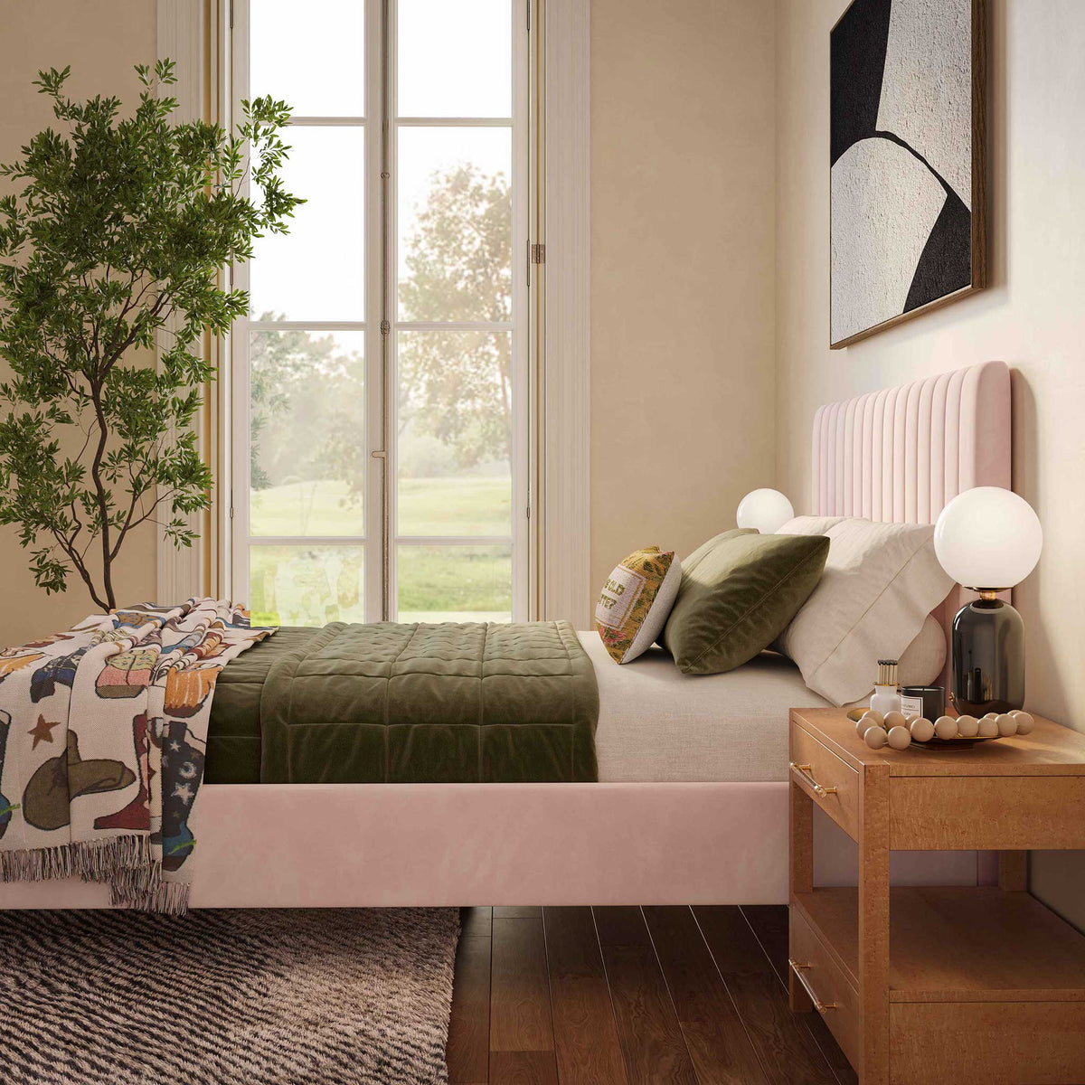 Soft blush velvet and a vertically channeled headboard create an inviting backdrop for layered bedding