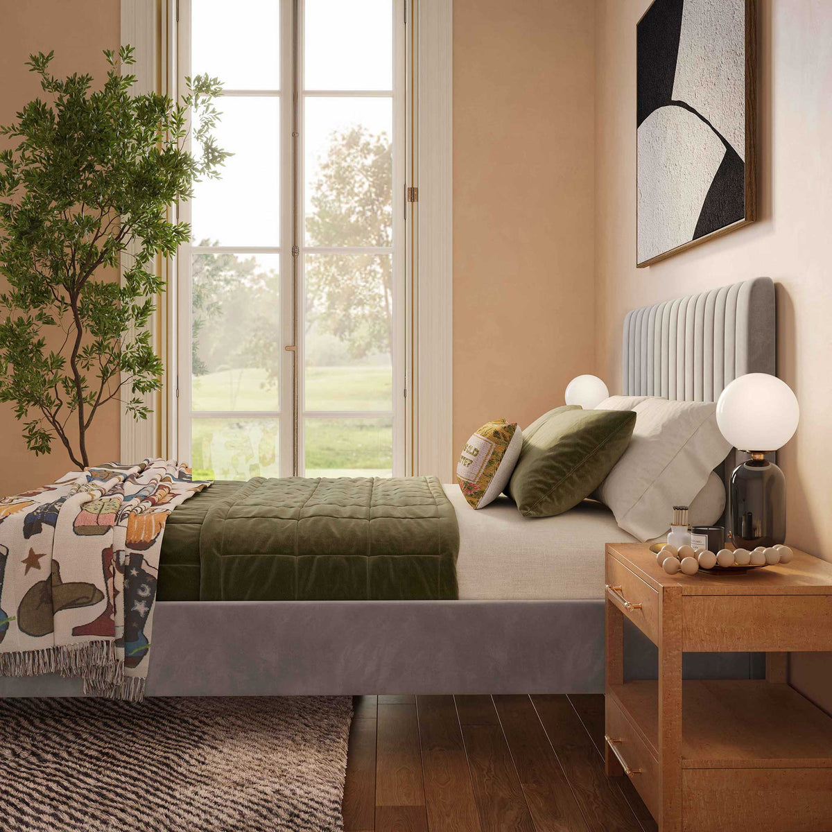 A gray velvet headboard with vertical channels offers a plush backdrop for richly layered bedding