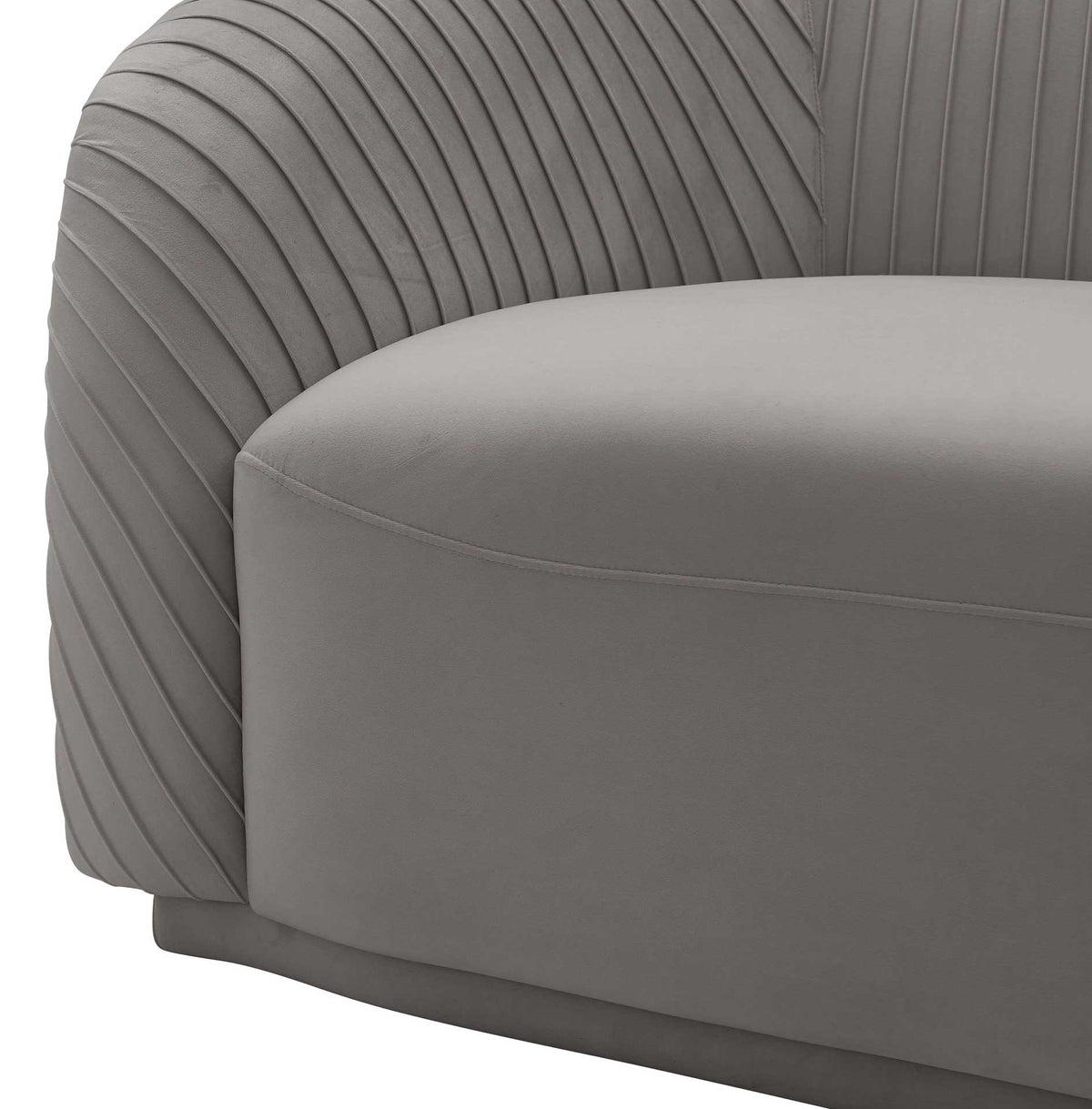 Fine pleats curve around a rolled arm, framing a thick gray velvet seat with tailored seam detailing