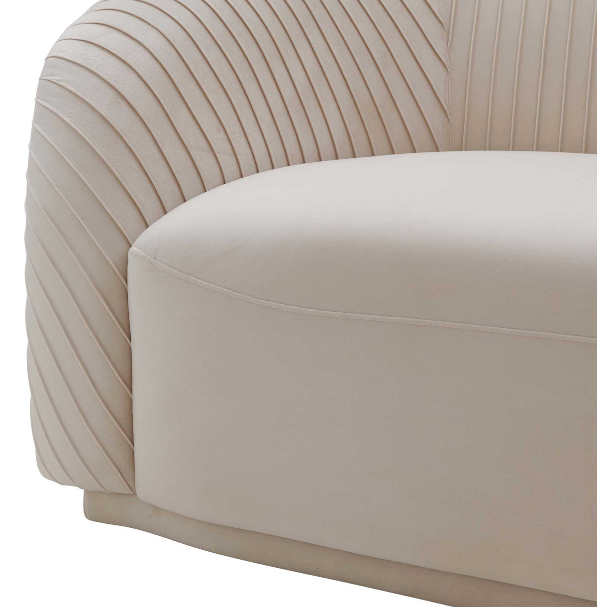 Sculpted pleats sweep over a rounded arm beside a plush beige velvet seat with clean seaming