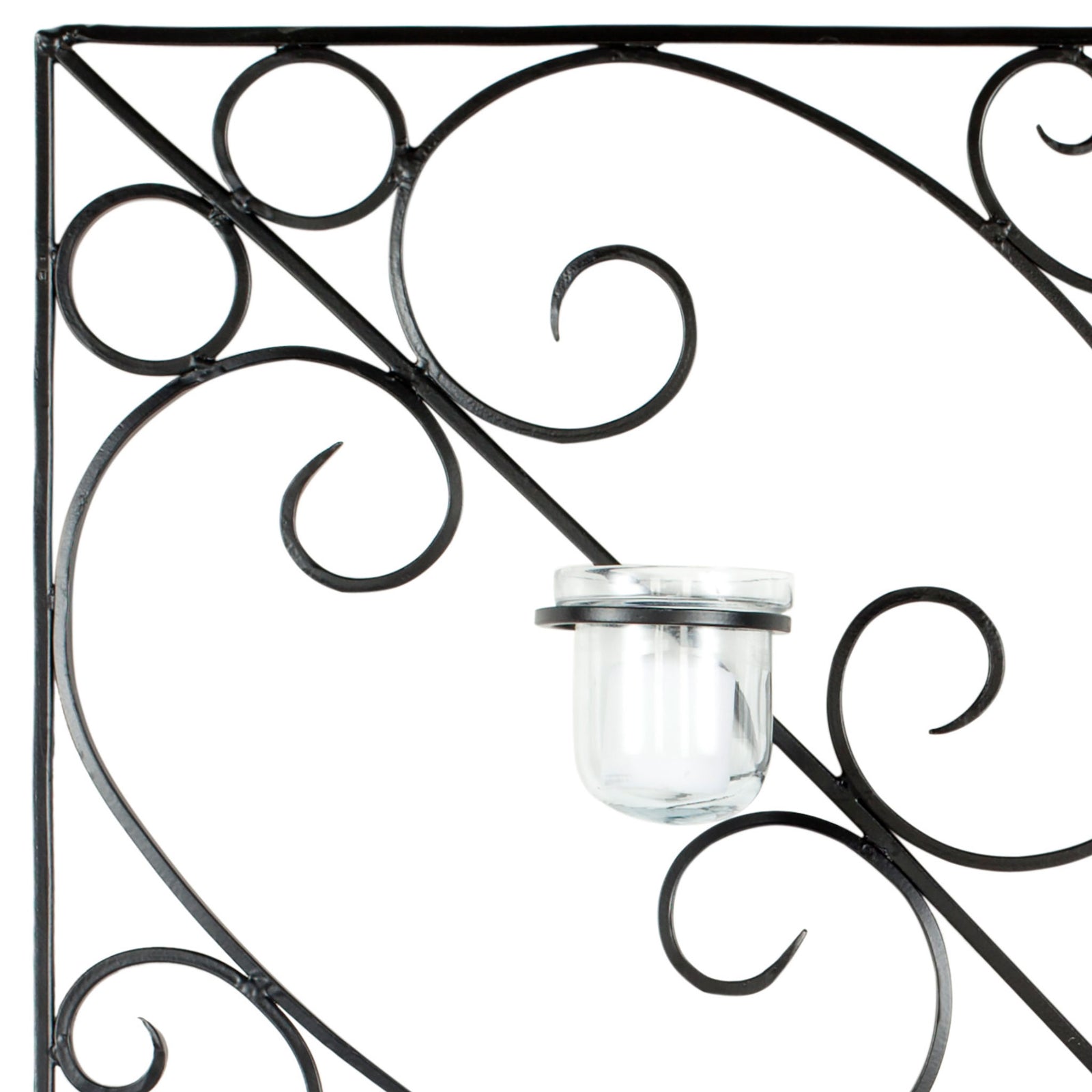 Curving black iron scrolls frame a clear glass votive cup with delicate metal detailing. || WDC1005A || detail_studio