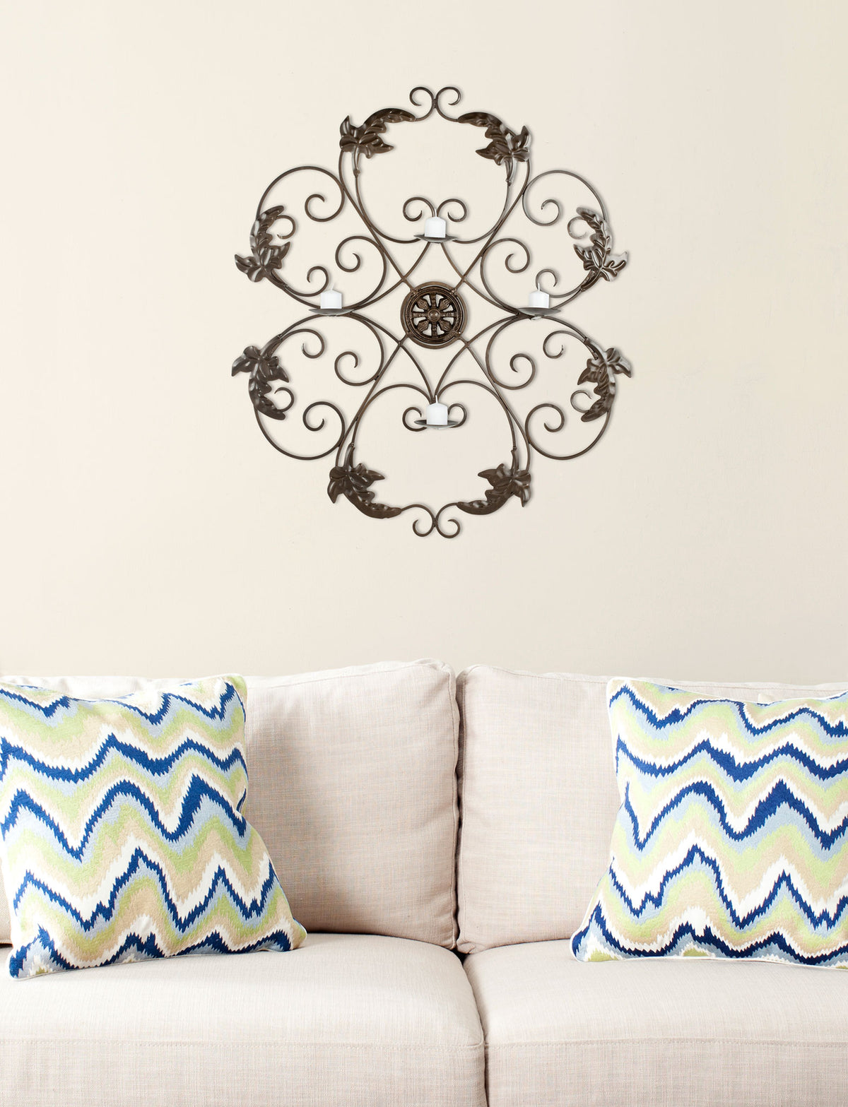 Dark iron scrollwork, leafy flourishes and four candleholders add ornate detail above a sofa. || WDC1006A || front_room