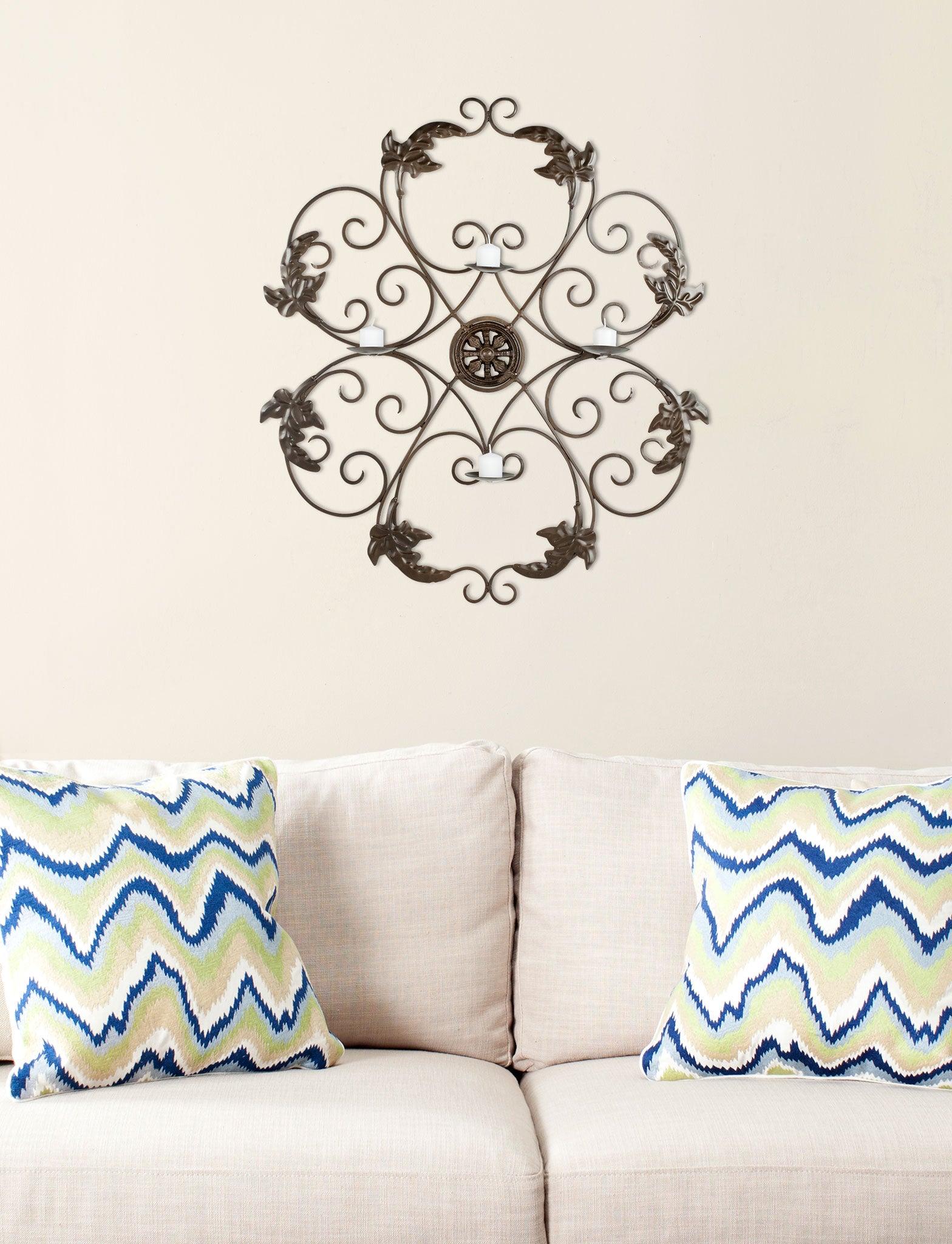 Dark iron scrollwork, leafy flourishes and four candleholders add ornate detail above a sofa. || WDC1006A || front_room