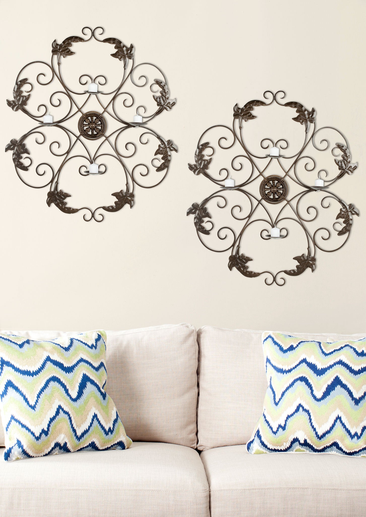 Two matching iron wall accents repeat graceful scrolls and leafy details for a balanced display. || WDC1006A || front_room