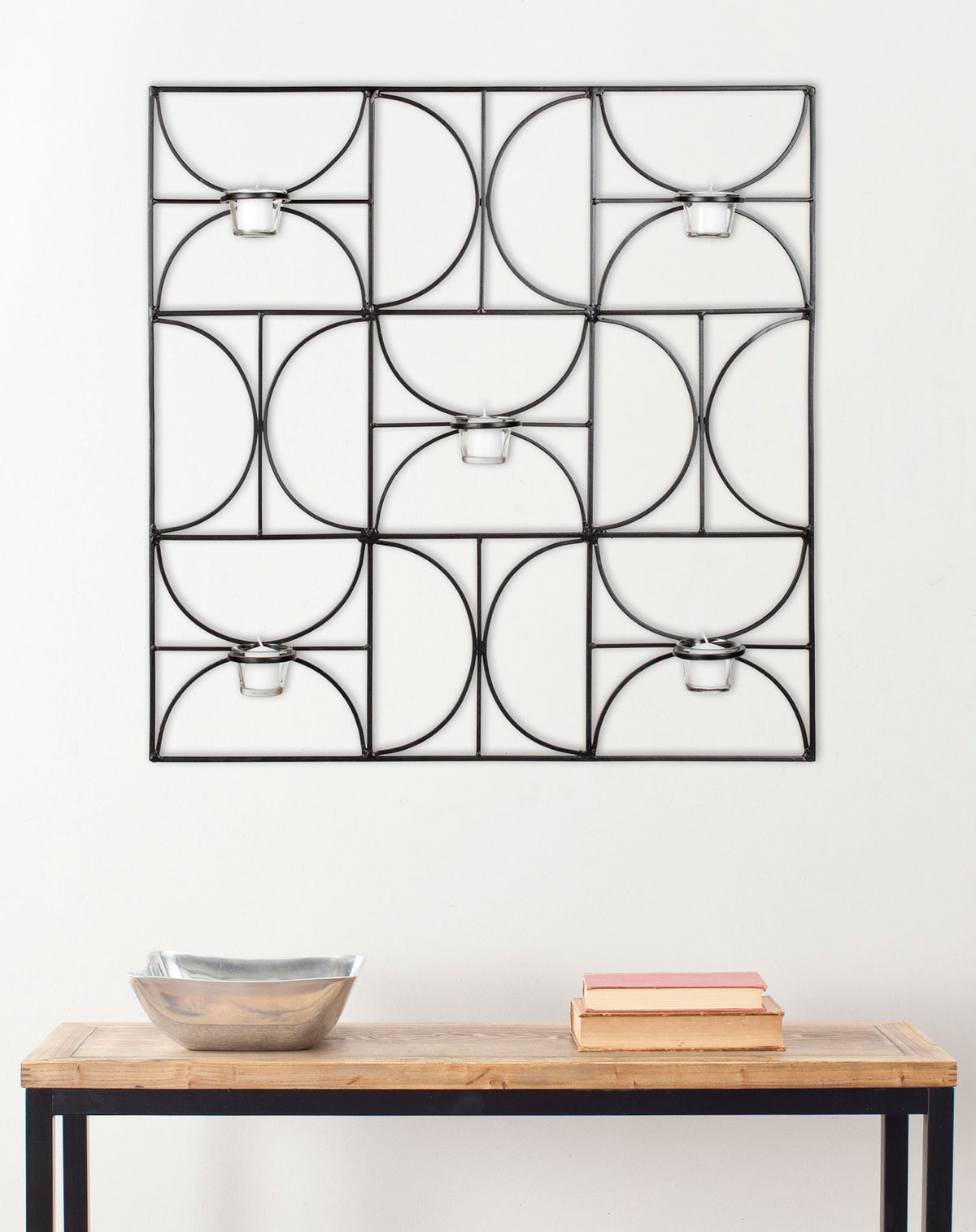 Black iron wall decor brings geometric curves and five glass votive holders to a bright room || WDC1007A || front_room