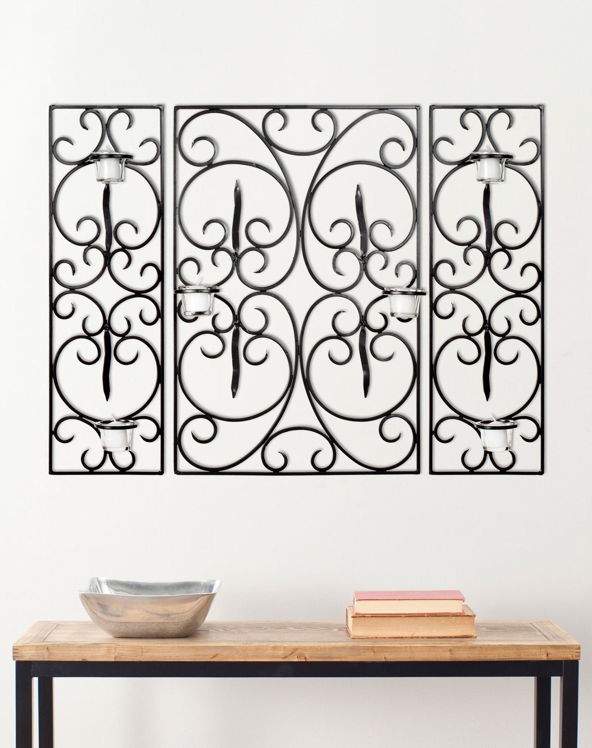 Three black iron panels with curling scrollwork and glass votive cups create an artistic wall accent. || WDC1009A || front_room