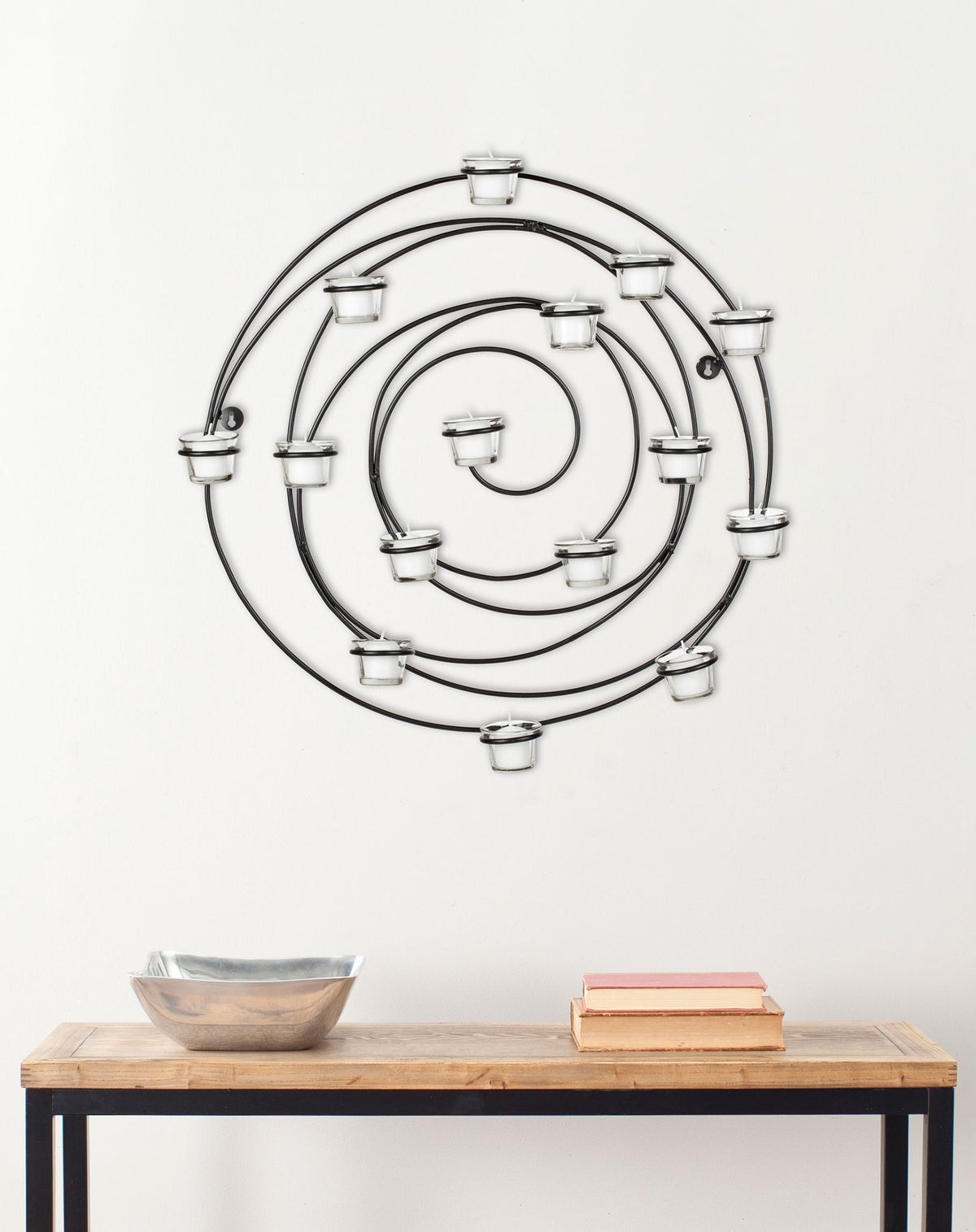 A sculptural spiral of black iron and glass votive holders adds dimension to a wall || WDC1011A || front_room