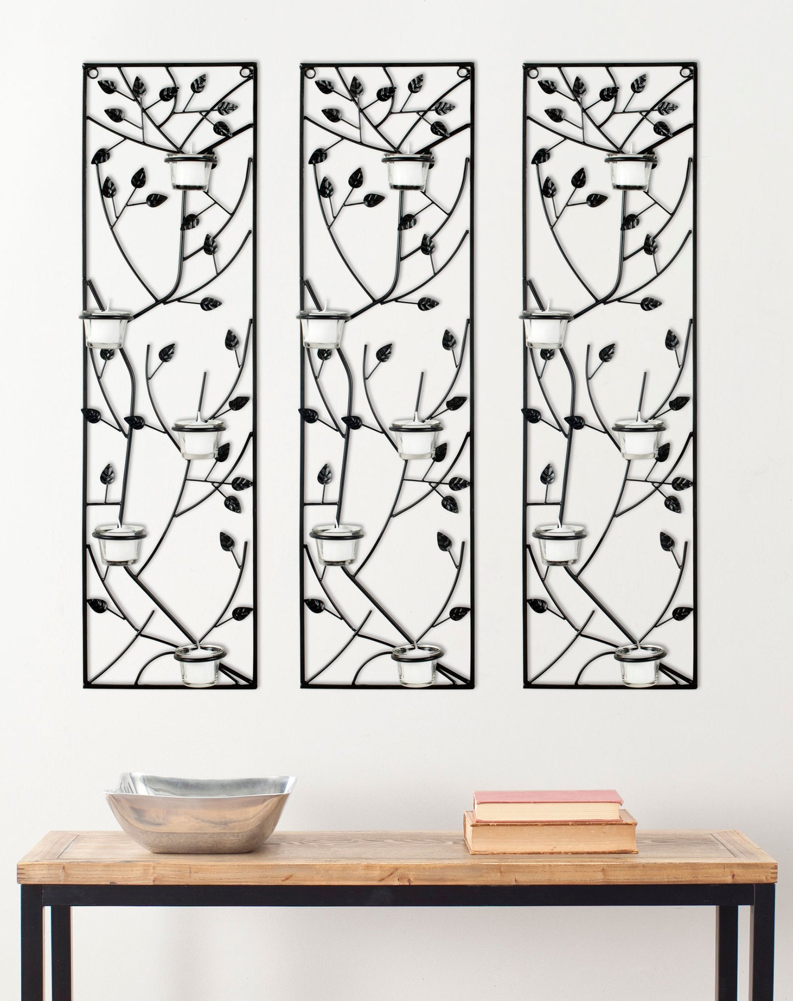 Three black iron leaf panels with glass votive holders create a striking accent above a console table || WDC1013A || front_multi_room