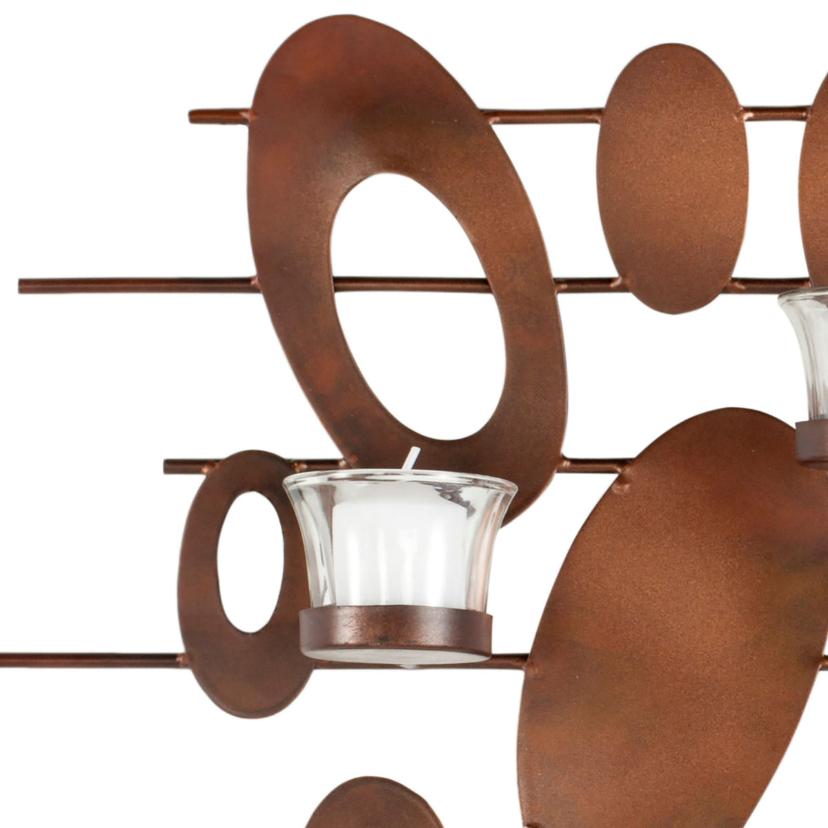 Warm rust-finished iron ovals mingle with a clear glass votive cup for layered texture. || WDC1015A || detail_studio