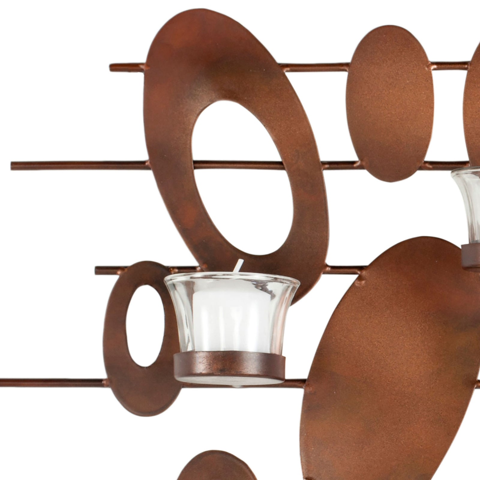 Warm rust-finished iron ovals mingle with a clear glass votive cup for layered texture. || WDC1015A || detail_studio