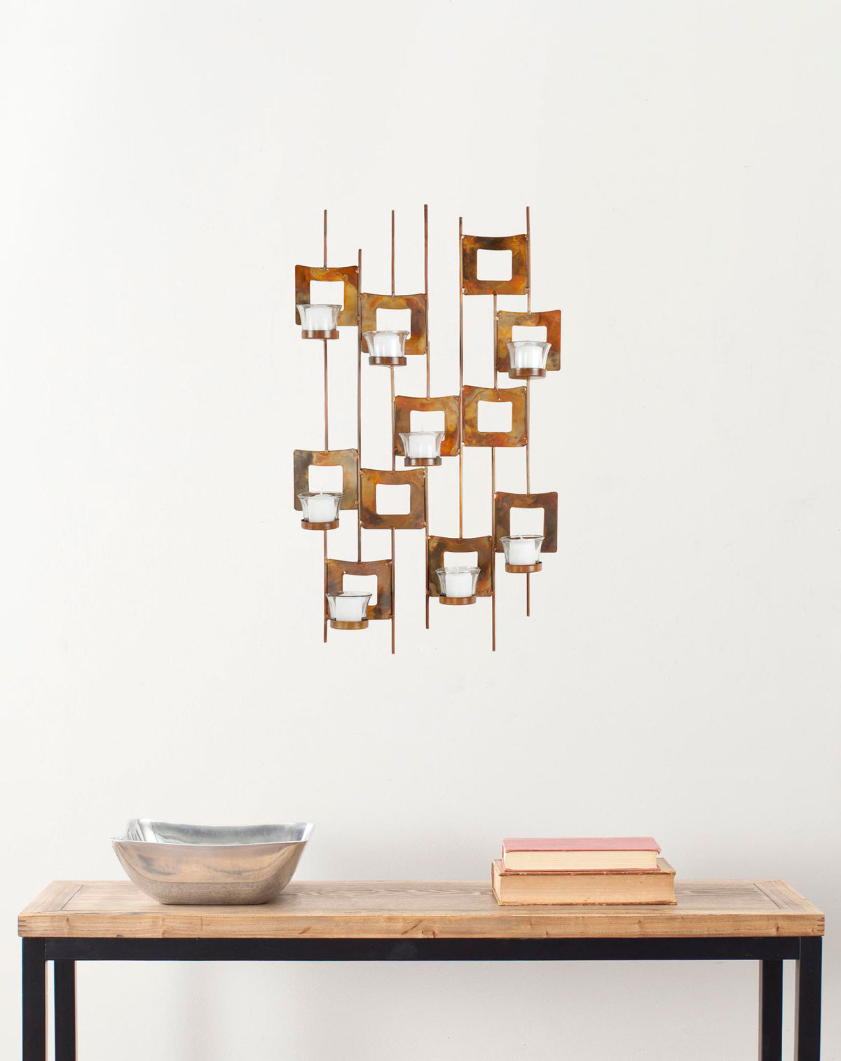 Antiqued metal squares and glass votives create a warm, modern accent on the wall. || WDC1017A || front_room