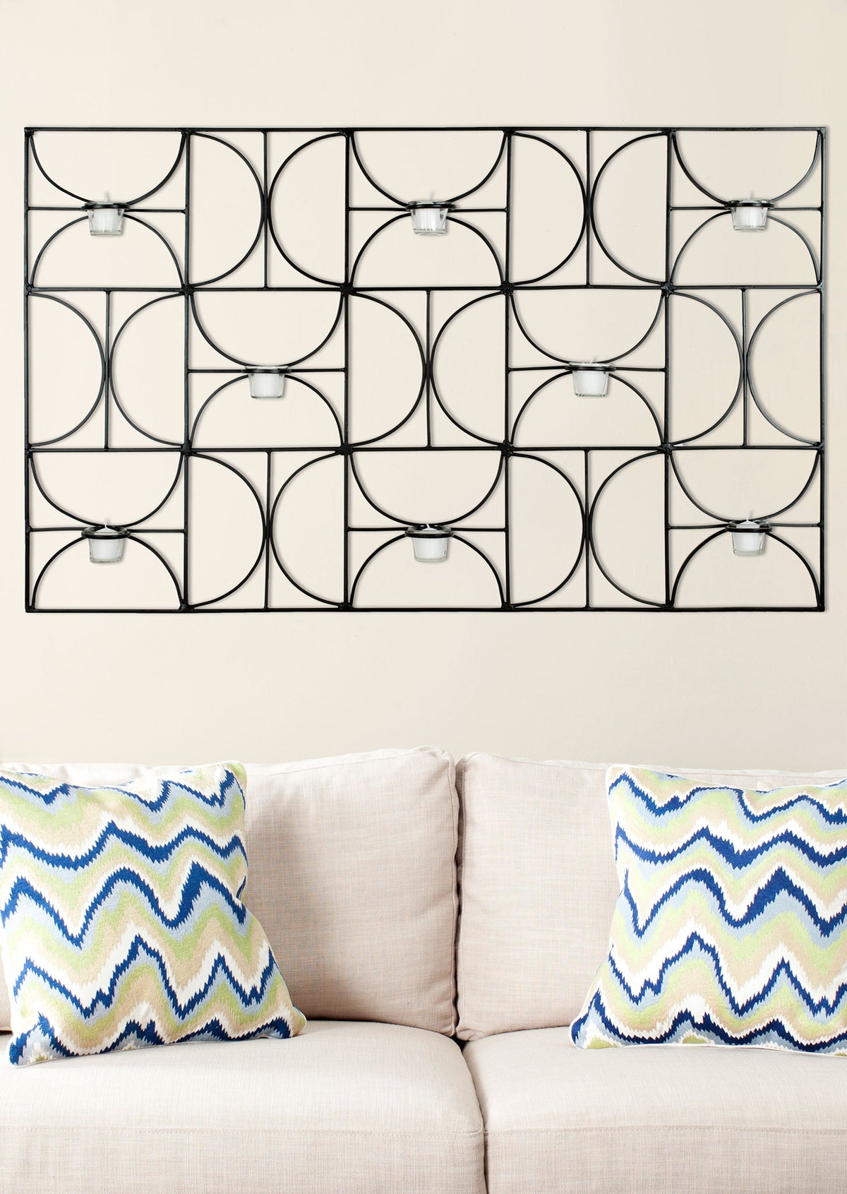 Curved black iron arcs form a graphic wall accent with eight clear glass votive holders. || WDC1019A || front_room