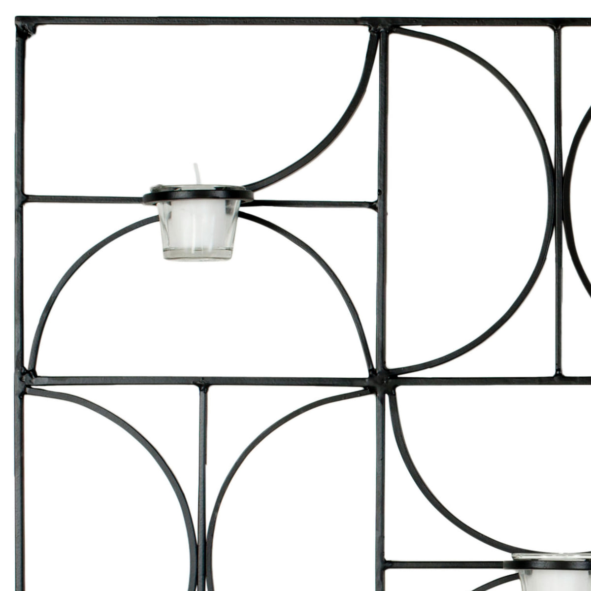 Black iron arcs cradle a clear glass votive cup amid crisp geometric lines. || WDC1019A || detail_studio