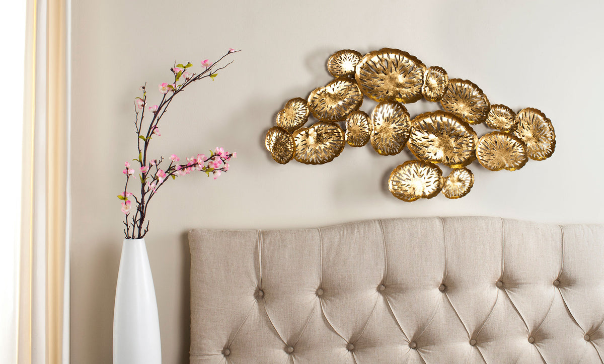Golden openwork coral forms create an airy wall accent above a tufted headboard || WDC1026A || front_room
