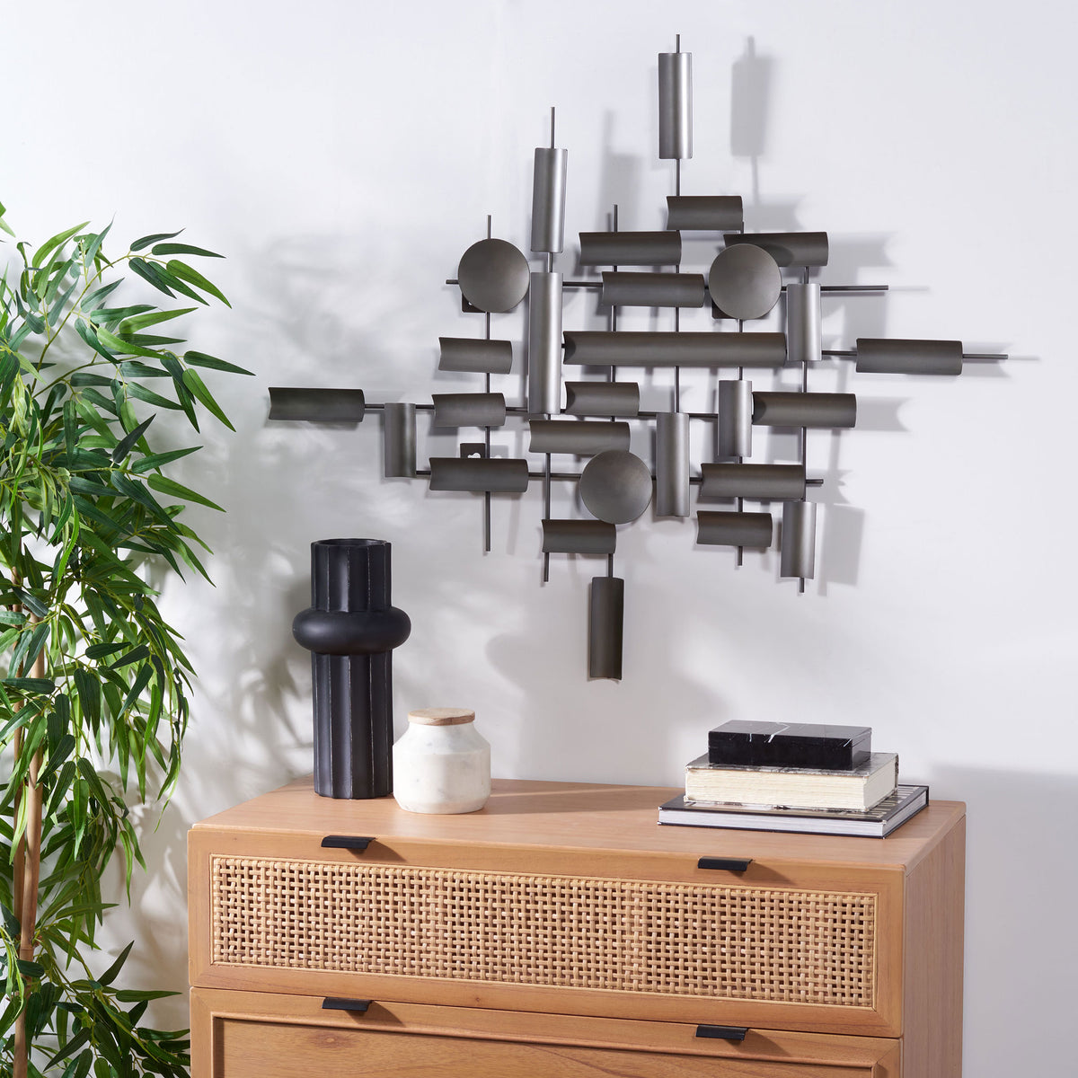 Antique silver iron wall accent creates a layered geometric focal point above a wood cabinet || WDC1027A || front_room