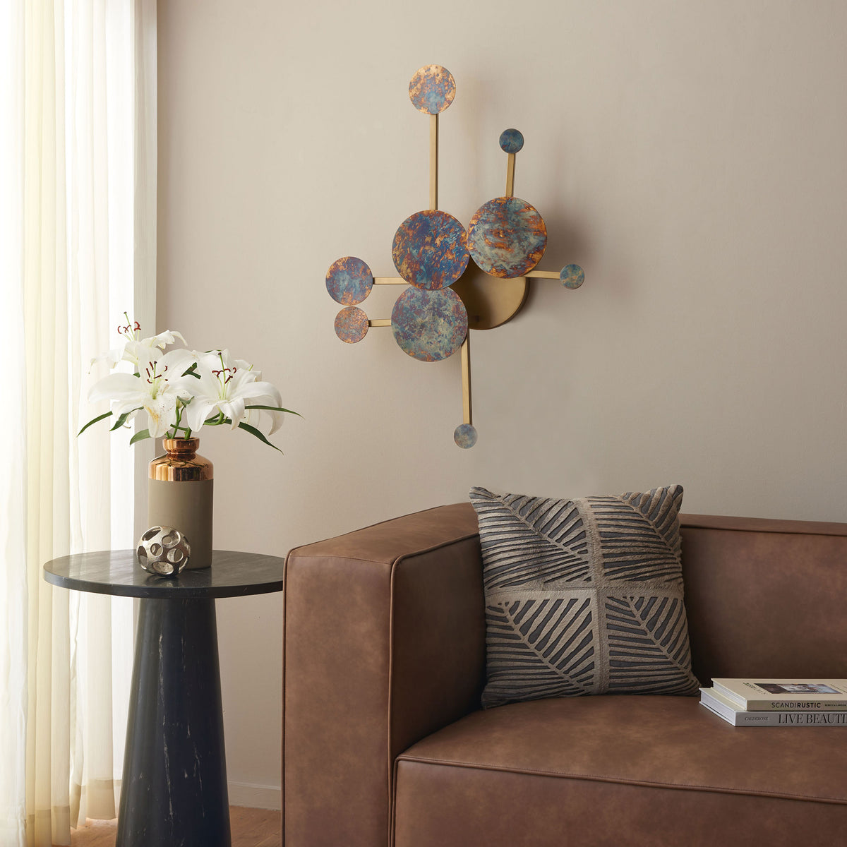 Sculptural circles in mottled blue and amber bring a metallic accent to the wall above a sofa. || WDC1032A || front_room