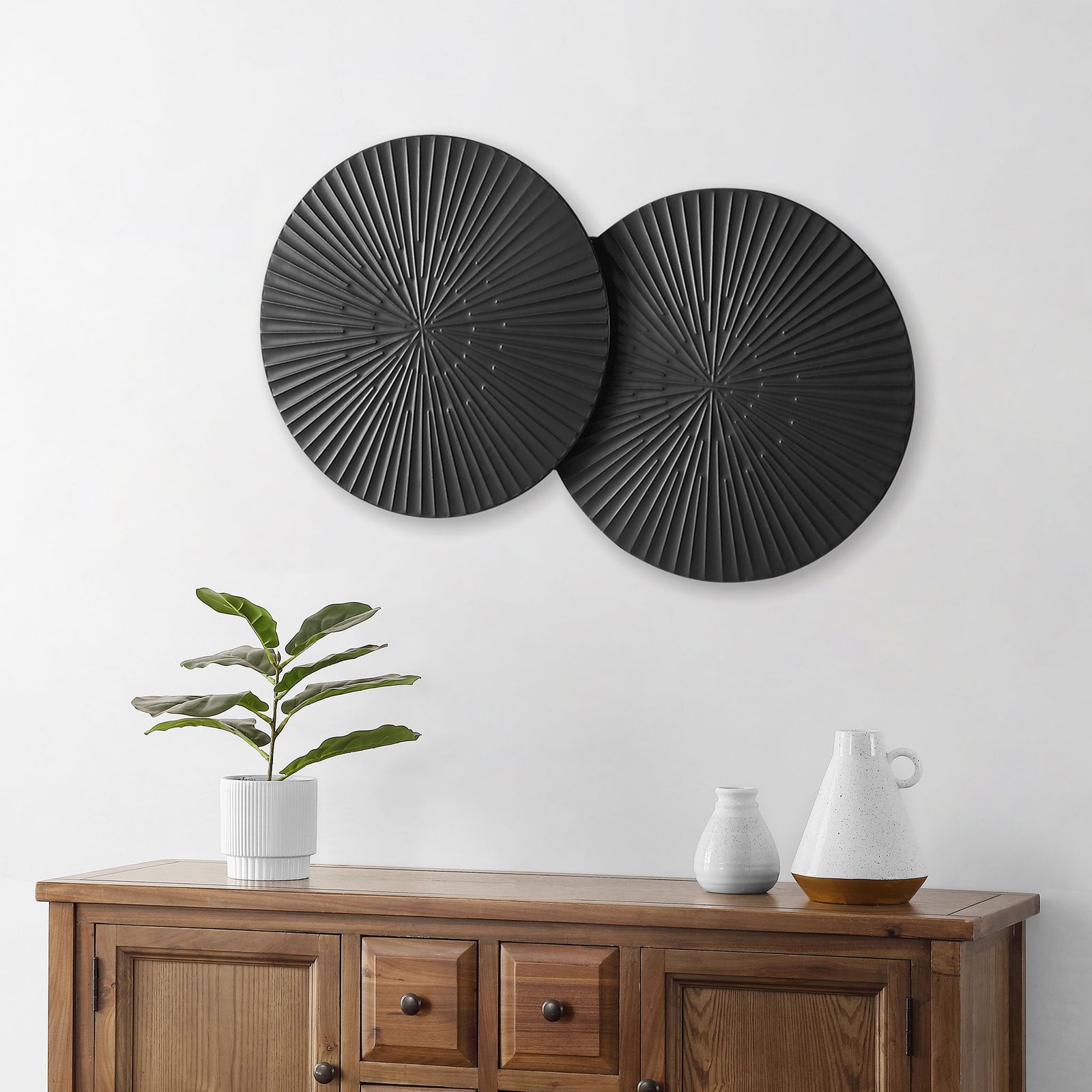 Black sunburst disks bring bold contrast and texture to a neutral wall. || WDC5012A || front_room