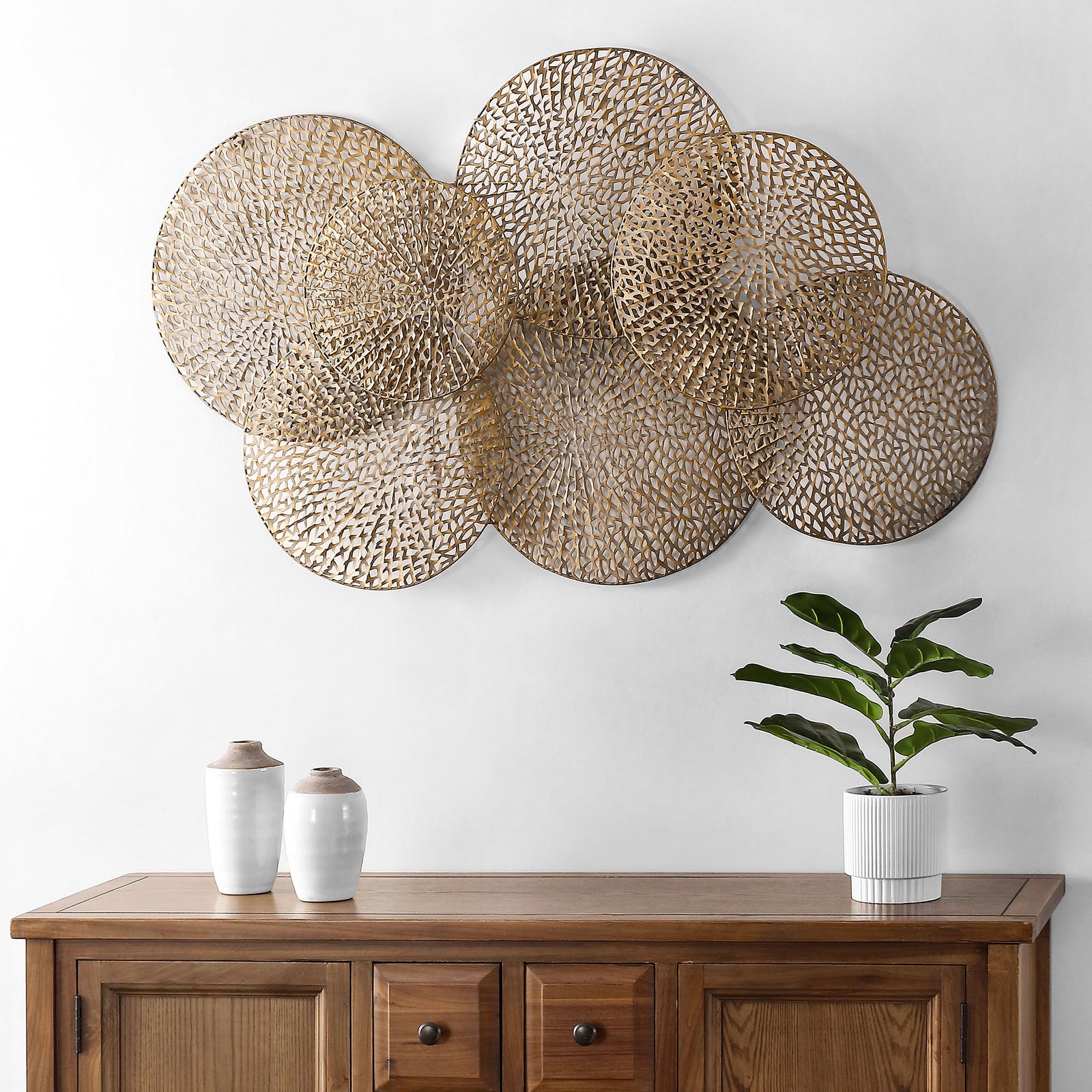 Layered openwork disks bring sculptural antique gold texture to the wall above a console || WDC5014A || front_room