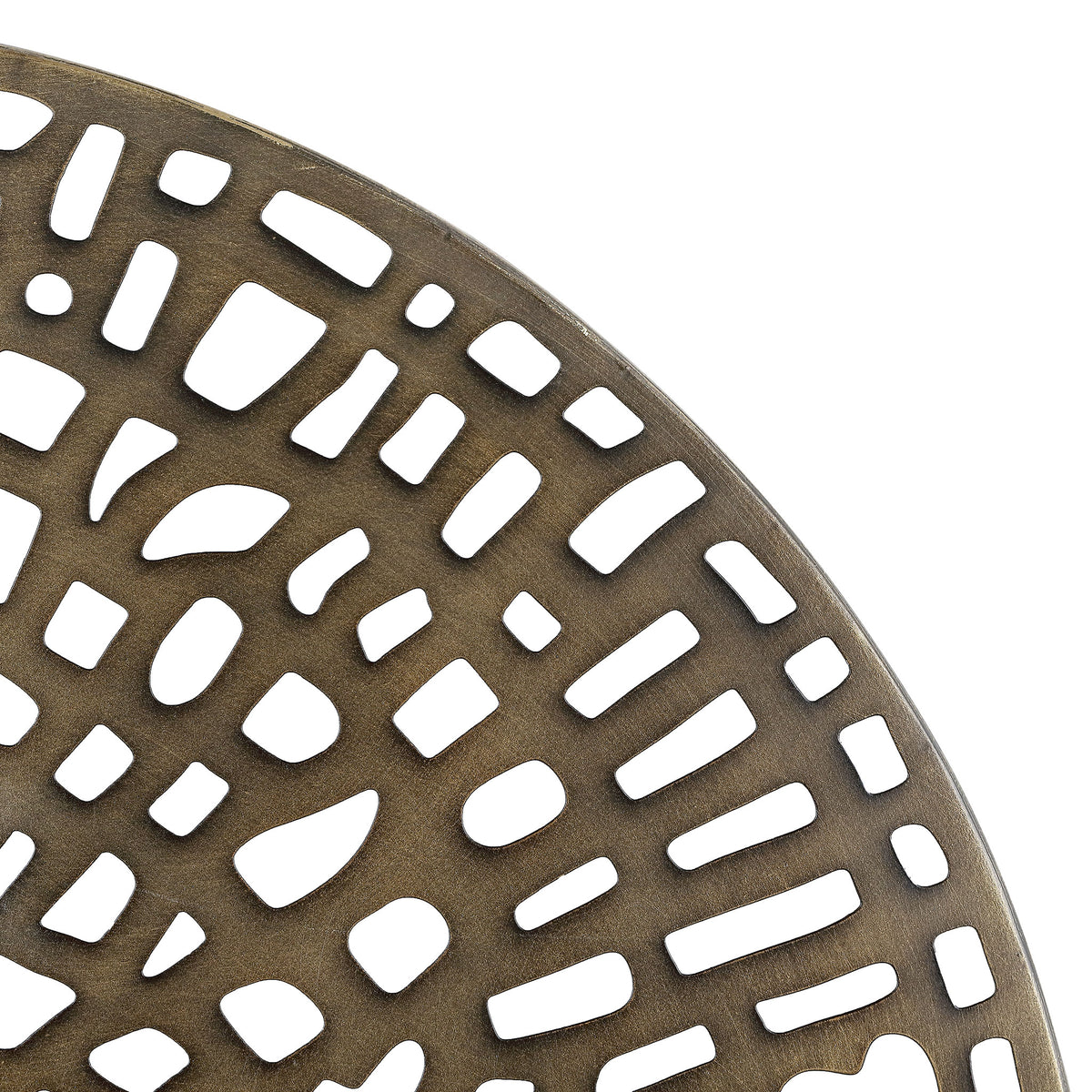 Textured antique brass metal frames a lattice of irregular cutouts