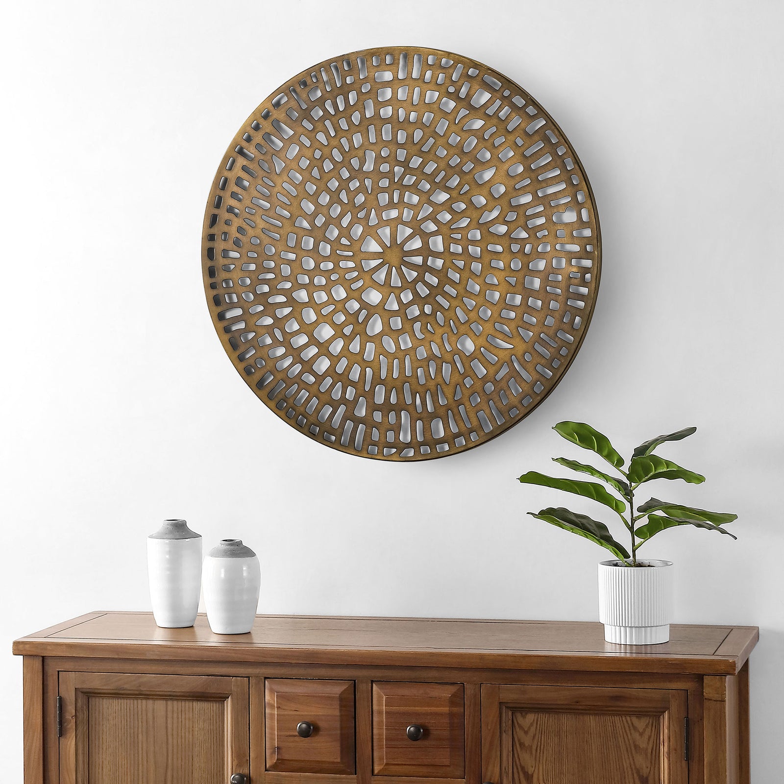 Antique brass openwork creates a warm, intricate focal point above a wood cabinet || WDC5017A || front_room