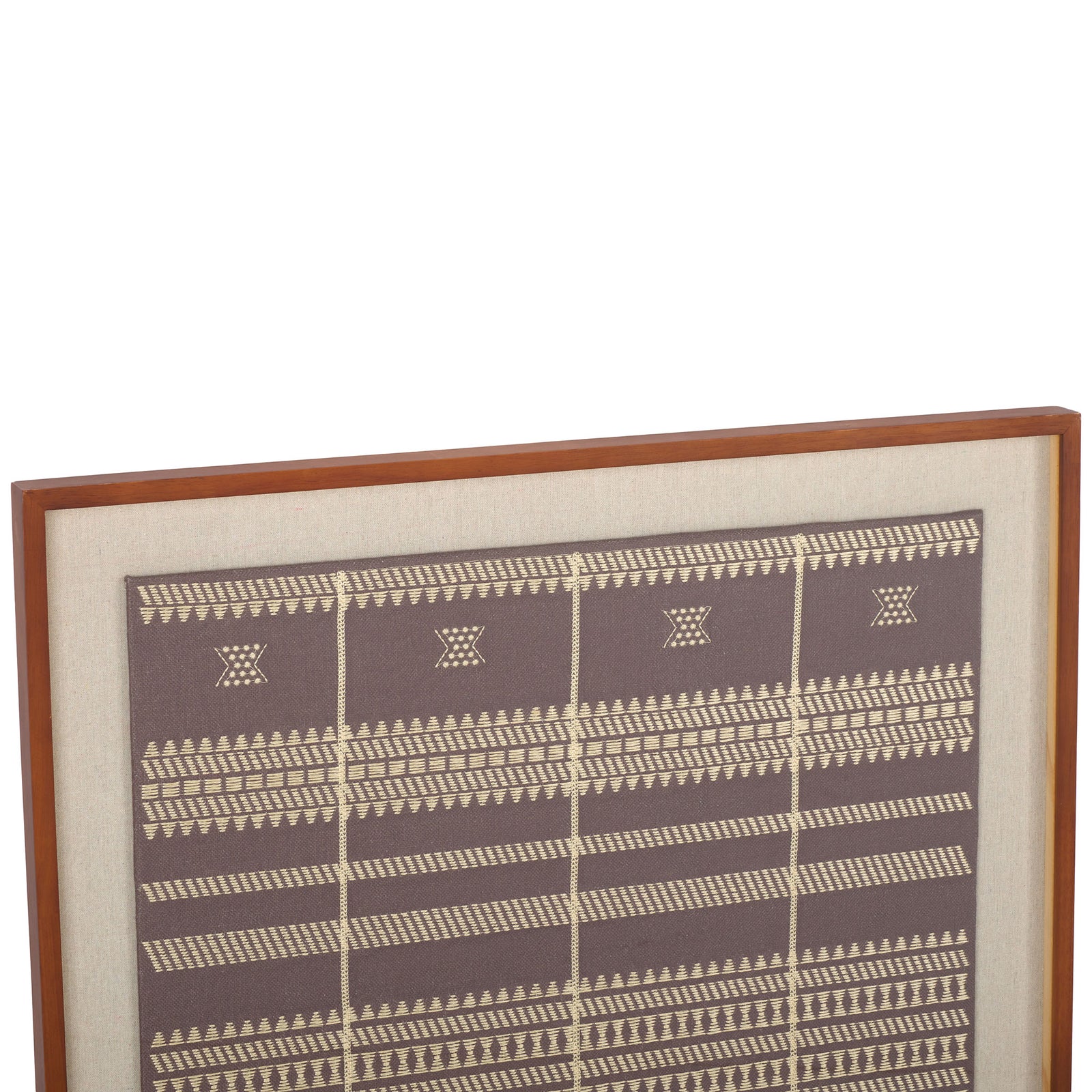 Rows of delicate cream motifs cross brown textile art within a slim wood frame. || WLA1902A || detail_studio