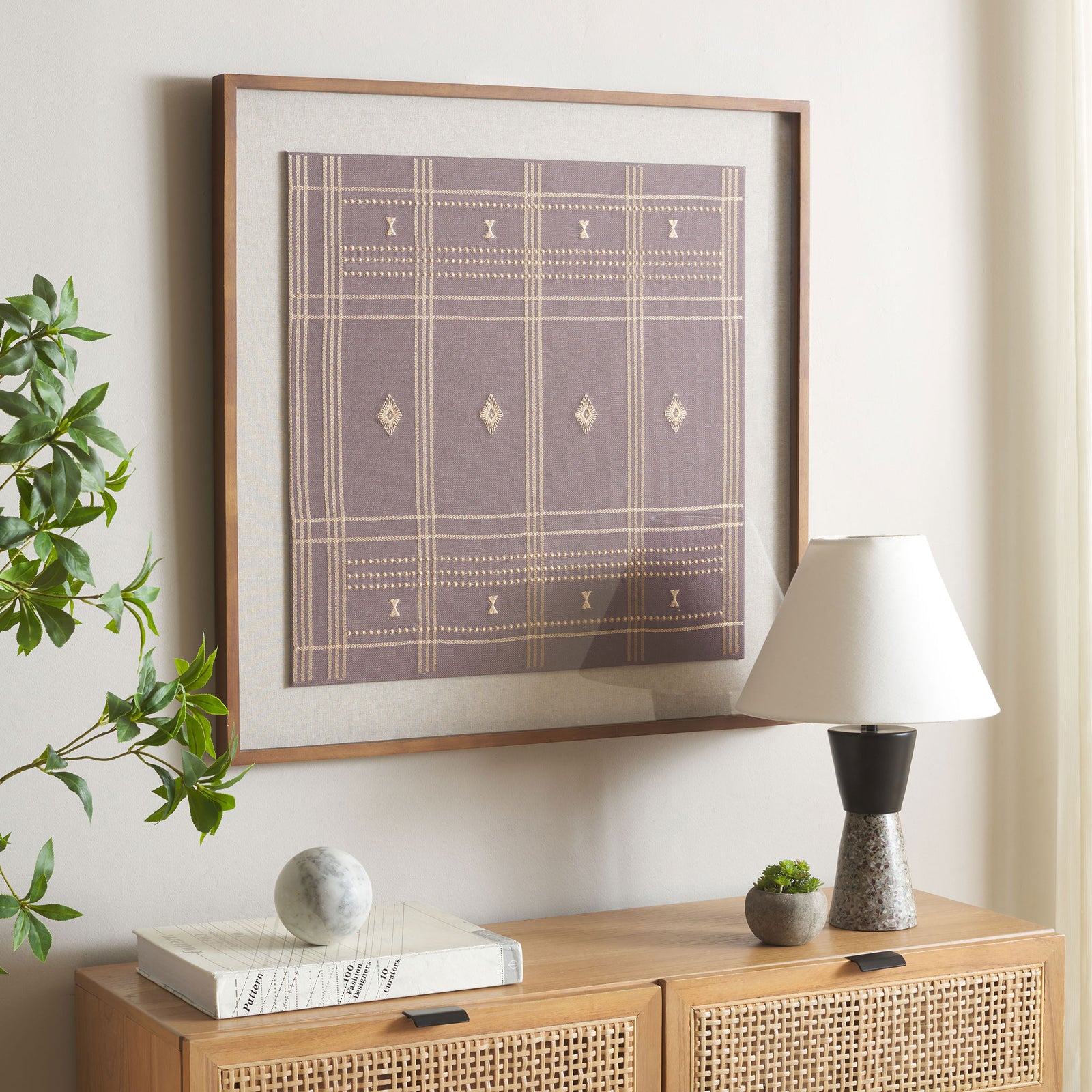 Geometric brown textile art adds warmth and quiet pattern above a wood console. || WLA1903A || front_angle_room