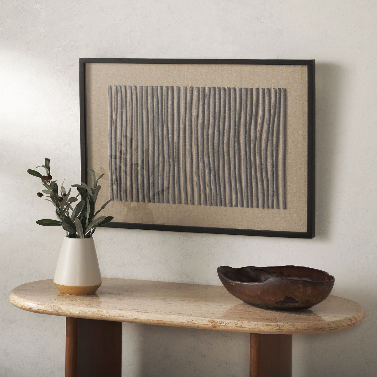 Framed linen wall art pairs textured vertical stitching with a dark border for understated modern appeal.