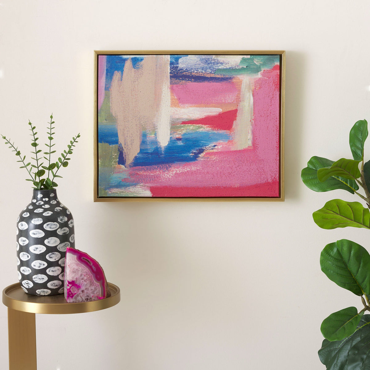 Abstract pink, blue, and teal canvas art lends vibrant color to a neutral wall.