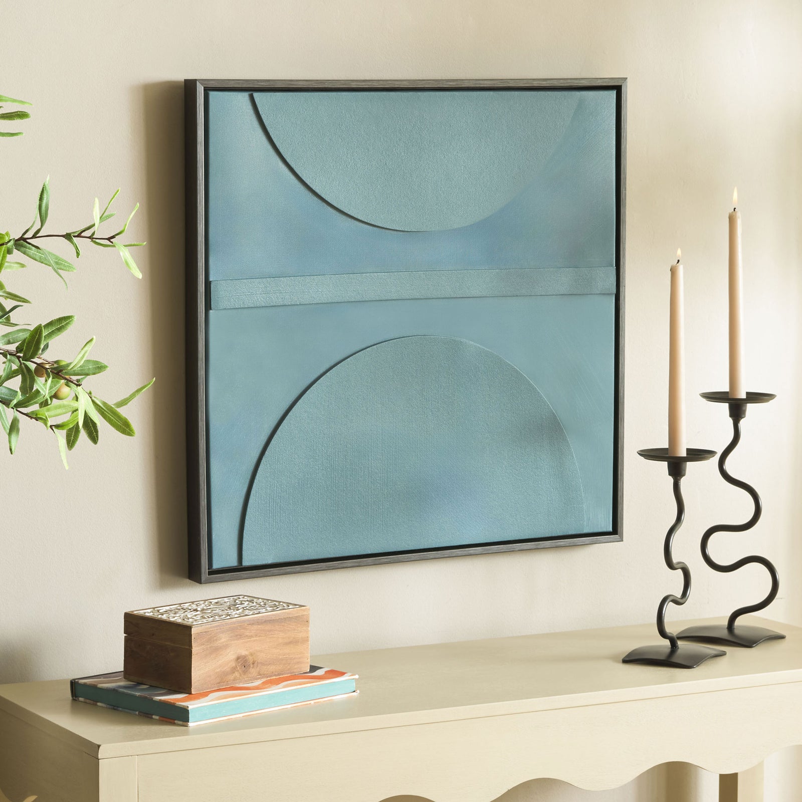 Modern blue-gray wall art brings sculptural curves and a dark outline above a light console. || WLA3028A || front_angle_room
