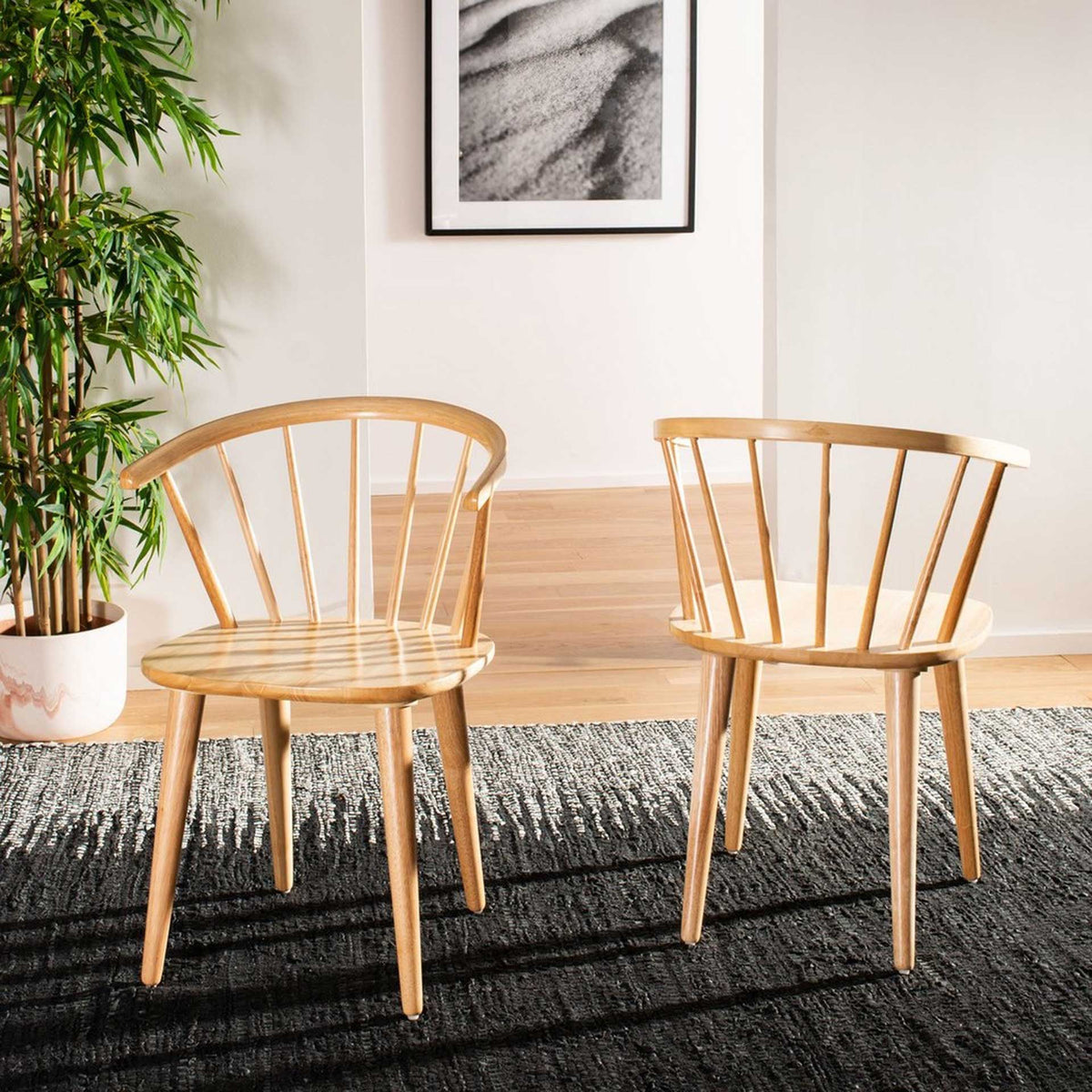 Two natural wood chairs add light, organic texture around a dining table.