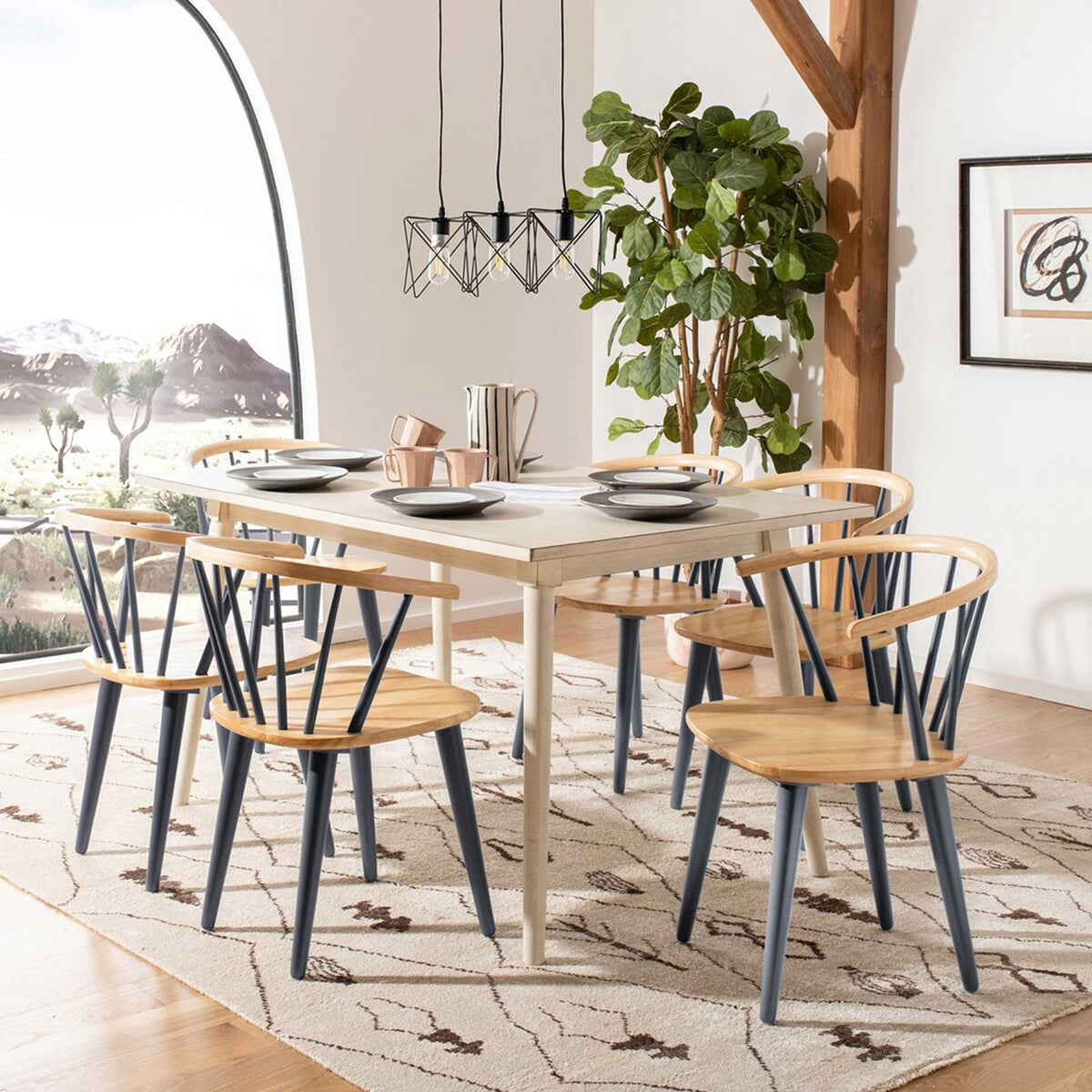 Curved wood back rails and dark gray spindles add warmth around a dining table.