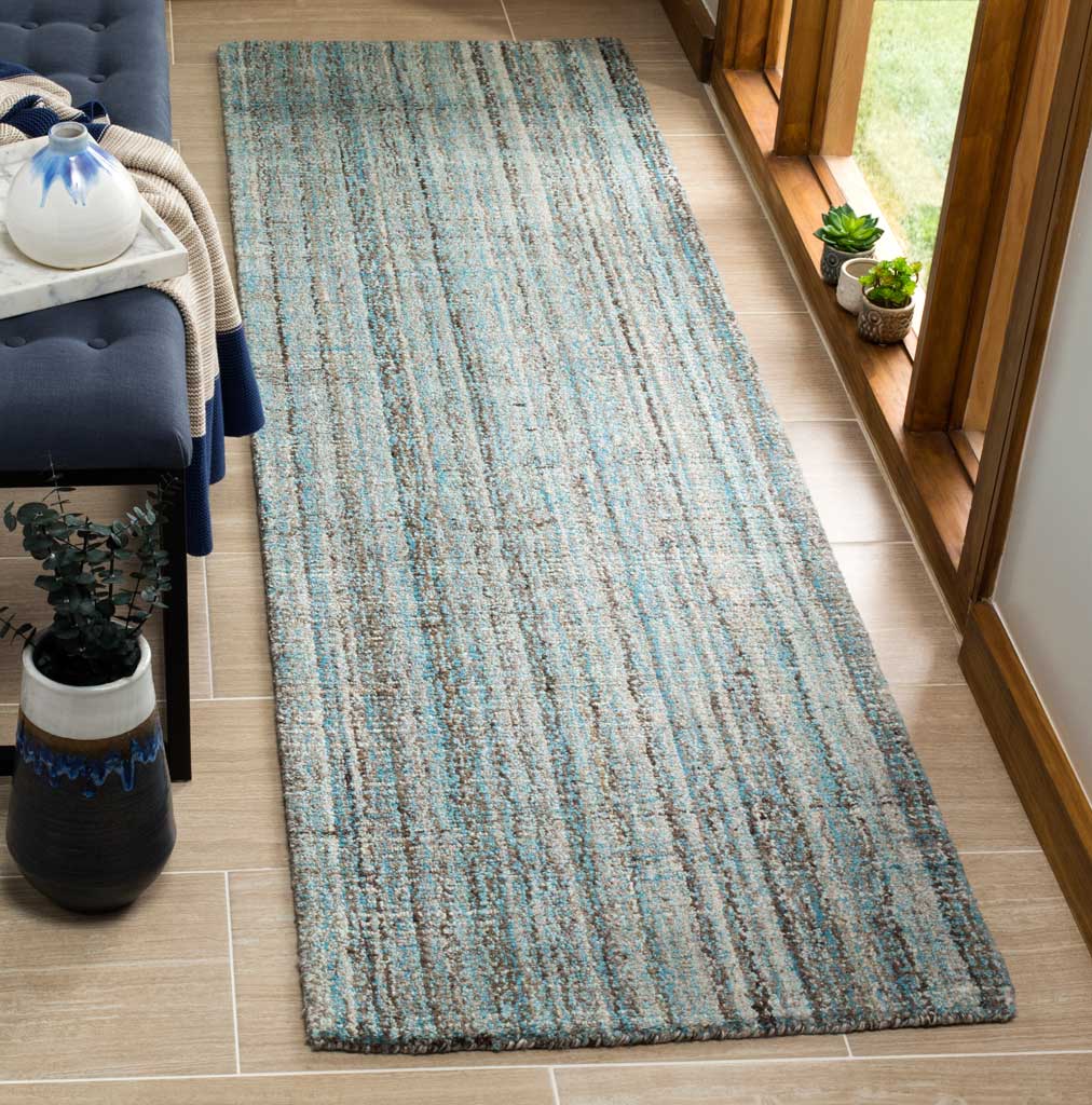 Cool blue tones and scattered multicolor lines add lively texture to this slender runner rug.