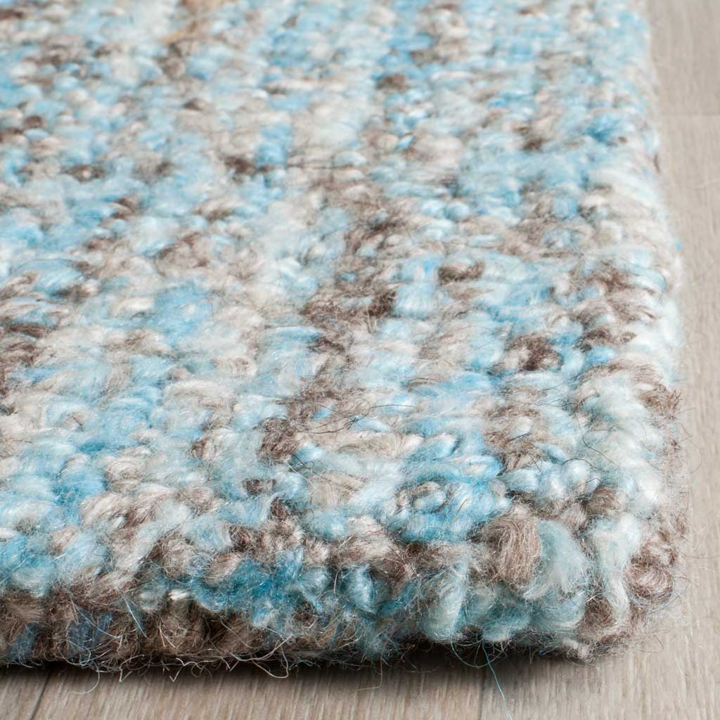 Plush blue and earthy-toned tufts create rich texture along a softly finished edge