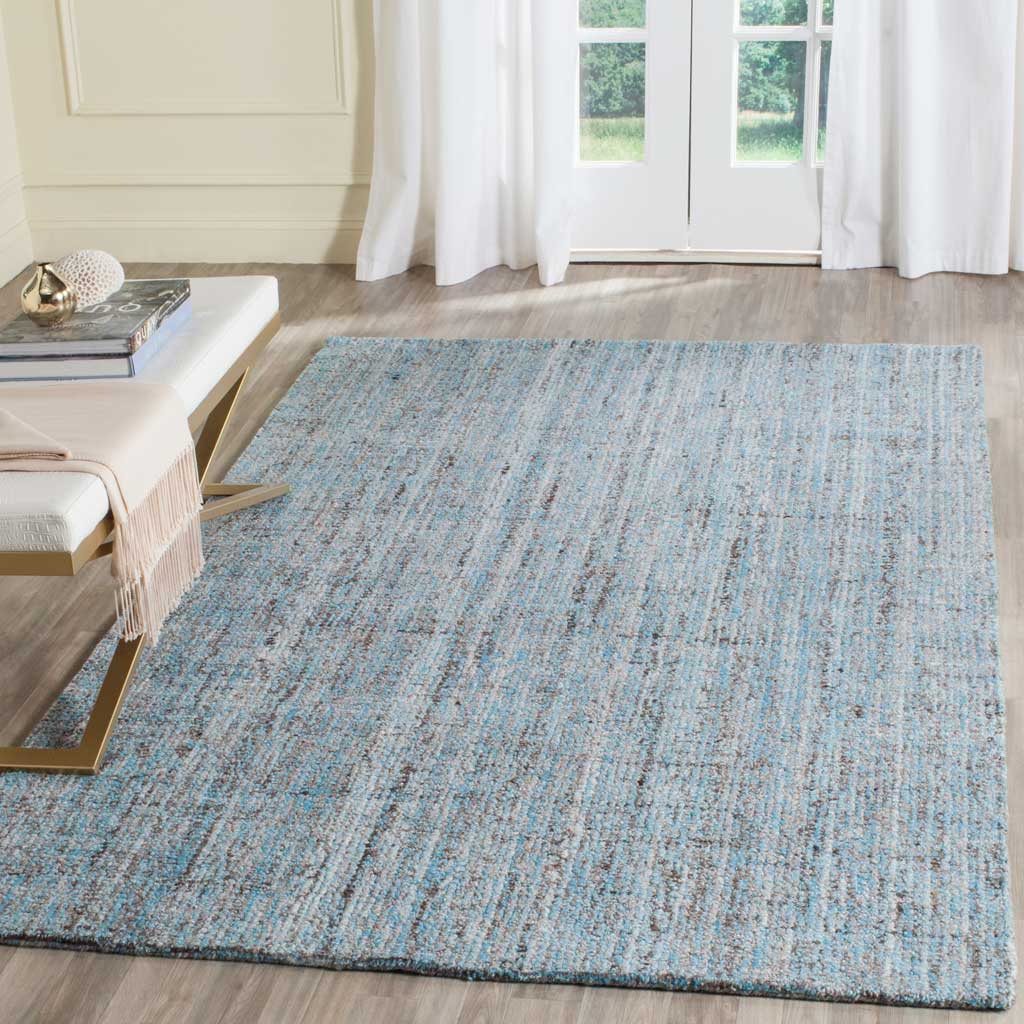 A blue rug adds cool color and a nuanced crosshatched design to the floor