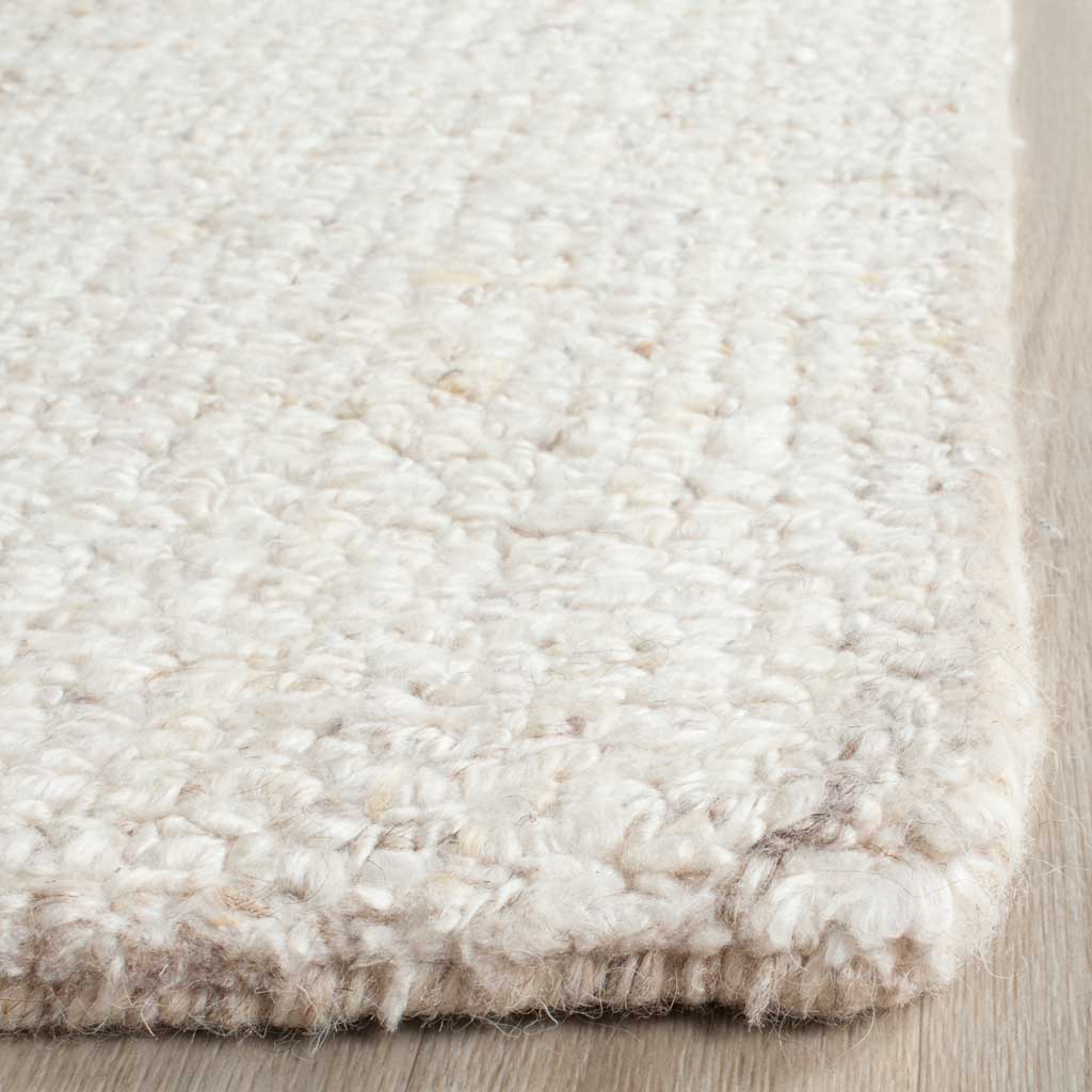 Plush ivory and beige tufts form a softly textured surface with a neatly finished edge