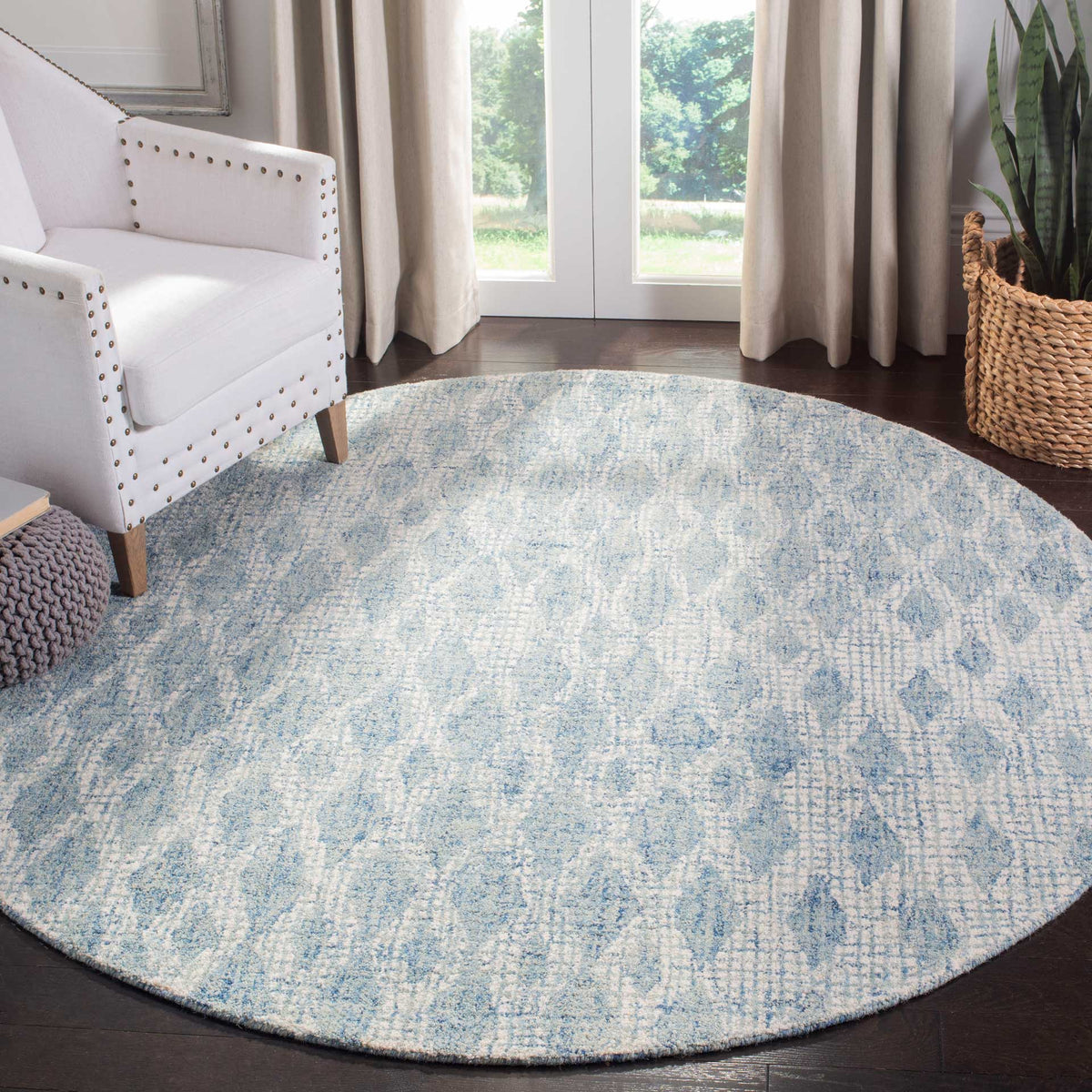 A round ivory and blue rug brings subtle abstract pattern to a bright seating area