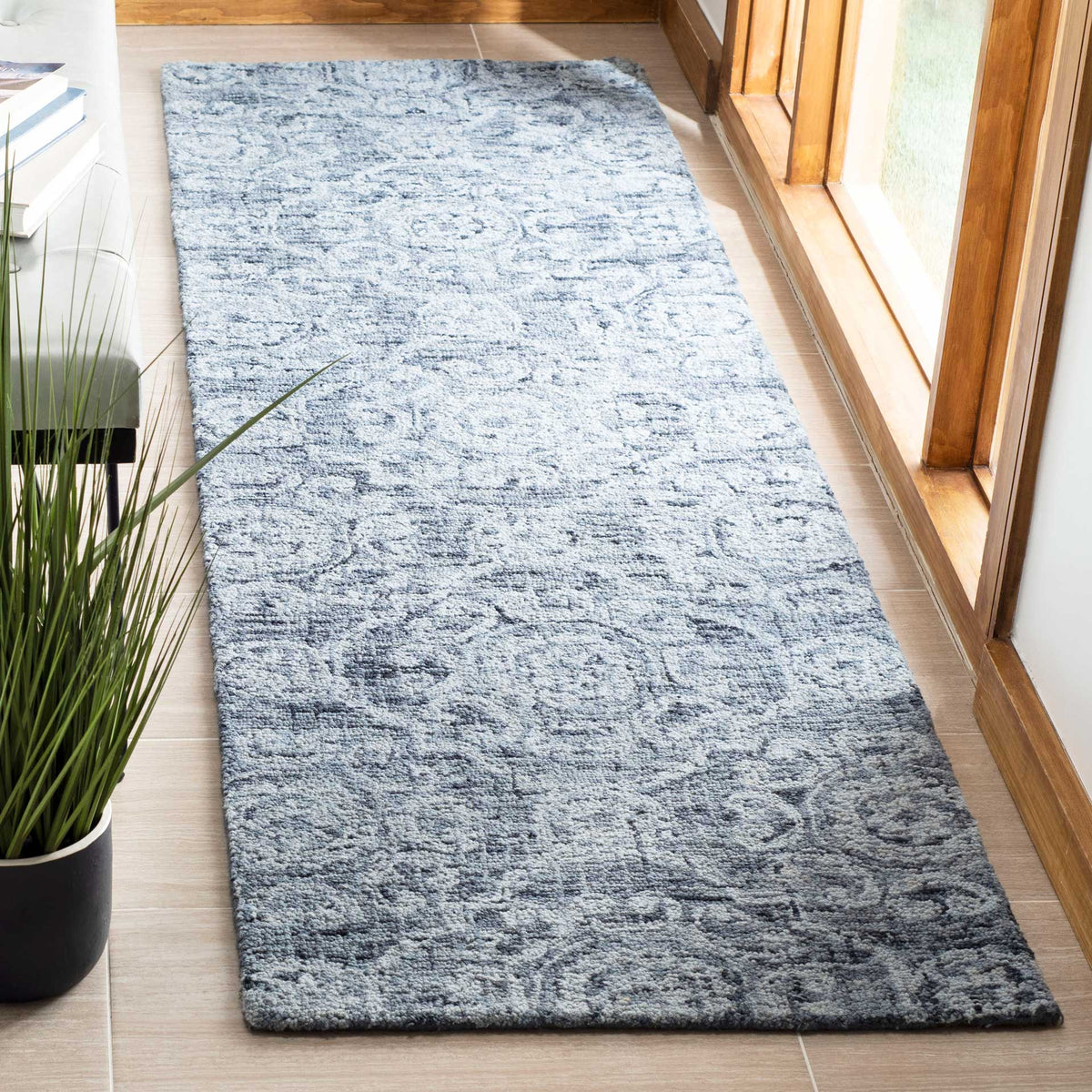 Soft blue wool runner with a faded, ornate pattern that adds subtle color to a hallway