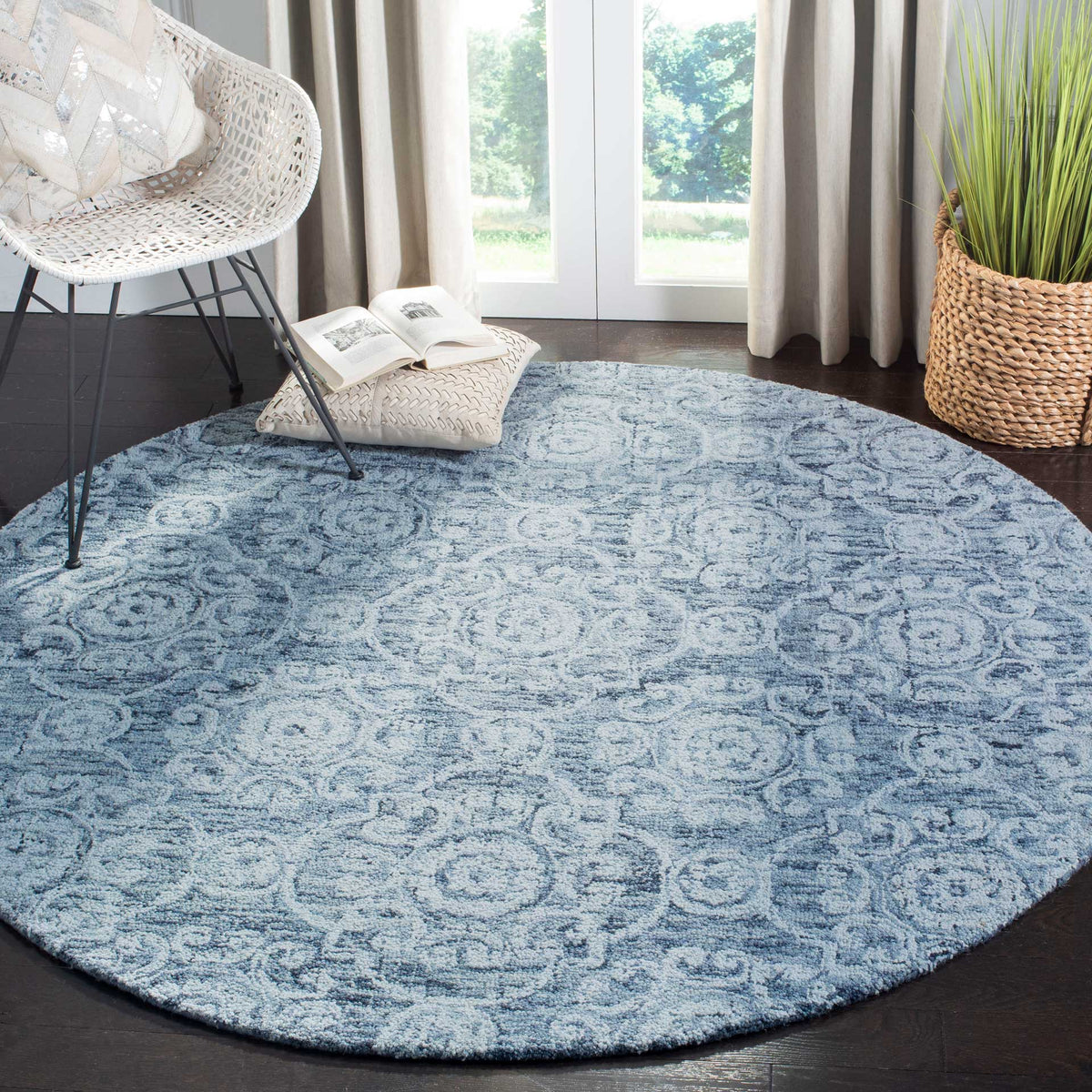 A round blue rug adds softly patterned texture beneath a cozy chair