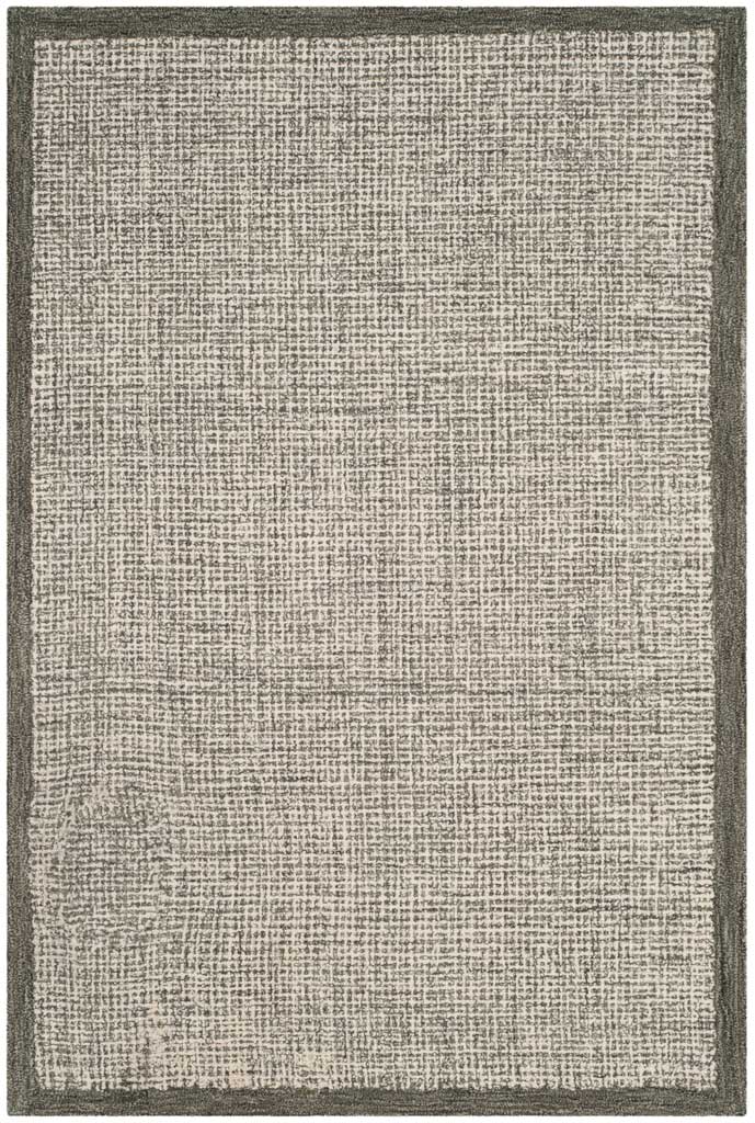 Compact ivory wool rug features dense sage markings and a neat contrasting frame.