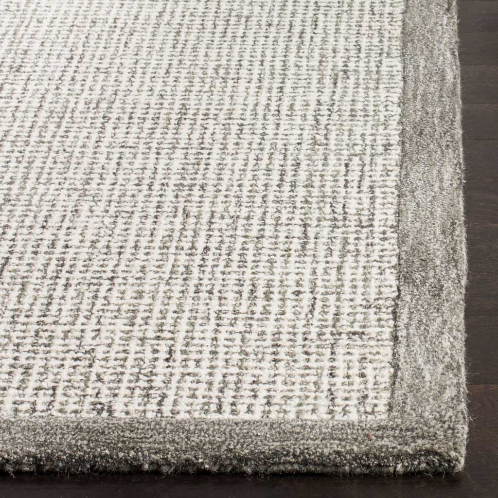Plush sage edging borders softly flecked ivory wool pile.