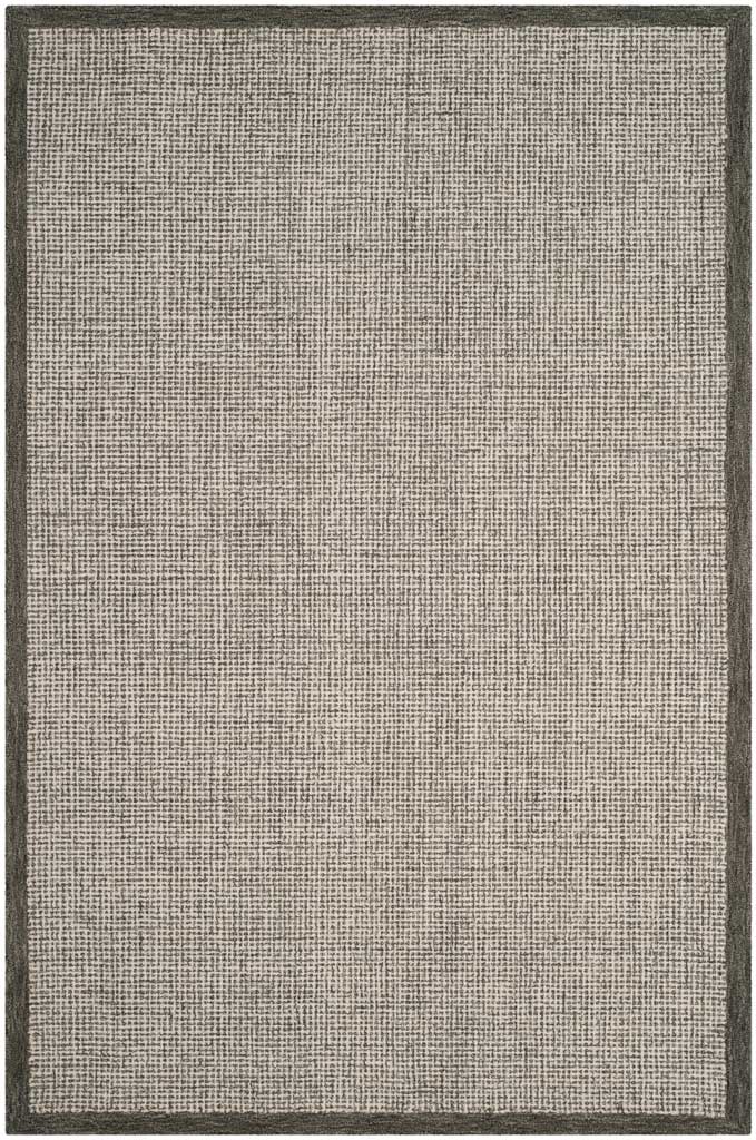 Hand-tufted sage and ivory rug blends a lightly speckled surface with a dark sage edge.