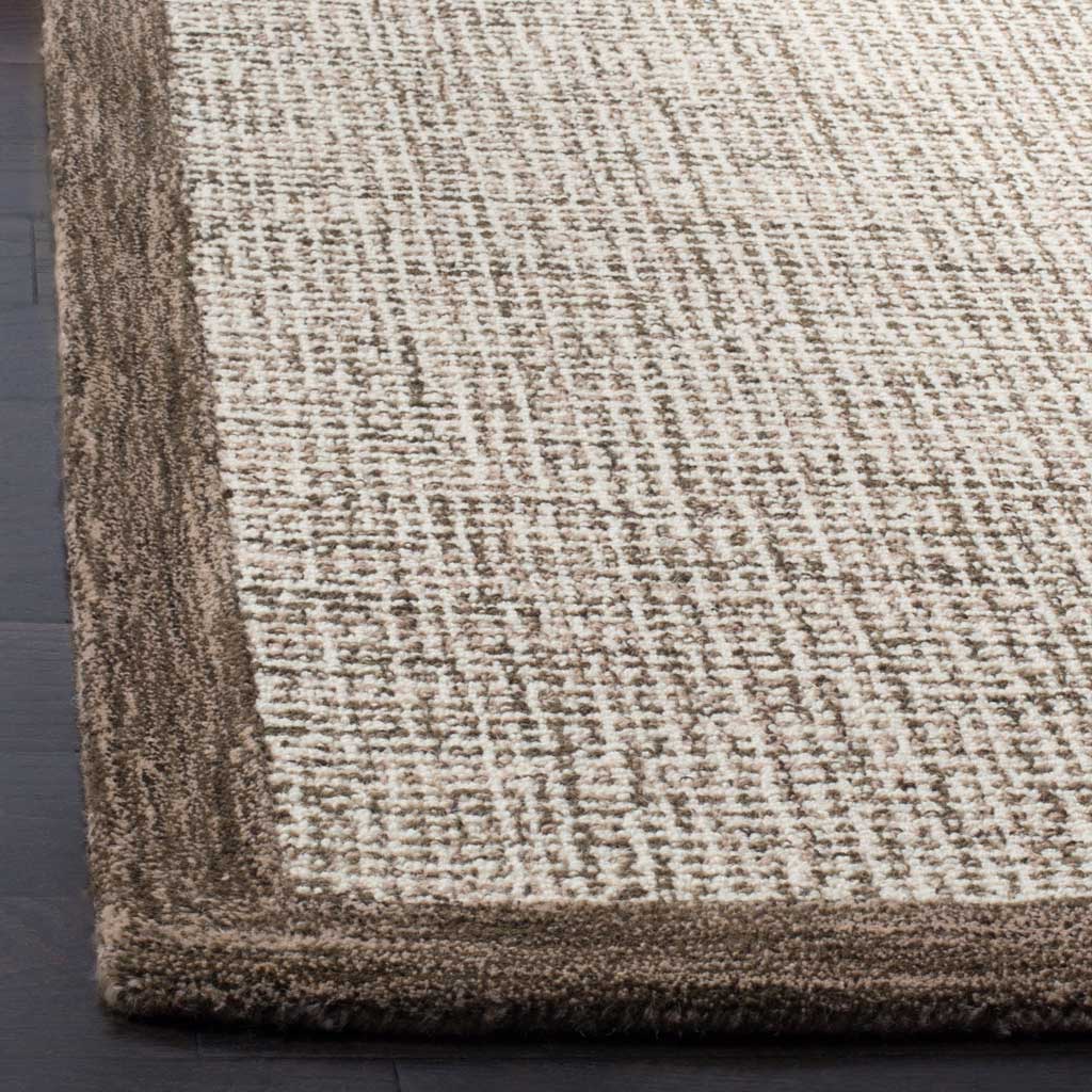 A plush brown border surrounds finely mottled ivory wool pile.