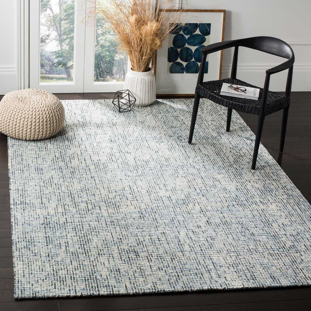 Subtle blue and charcoal flecks lend this wool rug an airy, relaxed feel for living spaces.