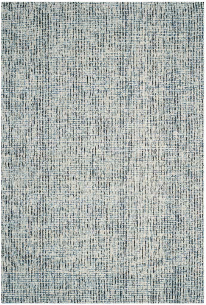 A hand-tufted wool pile blends cool blue and charcoal flecks into a finely mottled pattern.